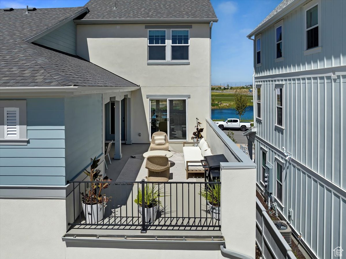 Wooden terrace featuring a water view and a patio