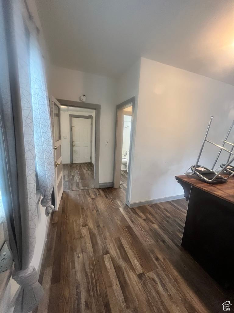 Hallway with dark wood-type flooring