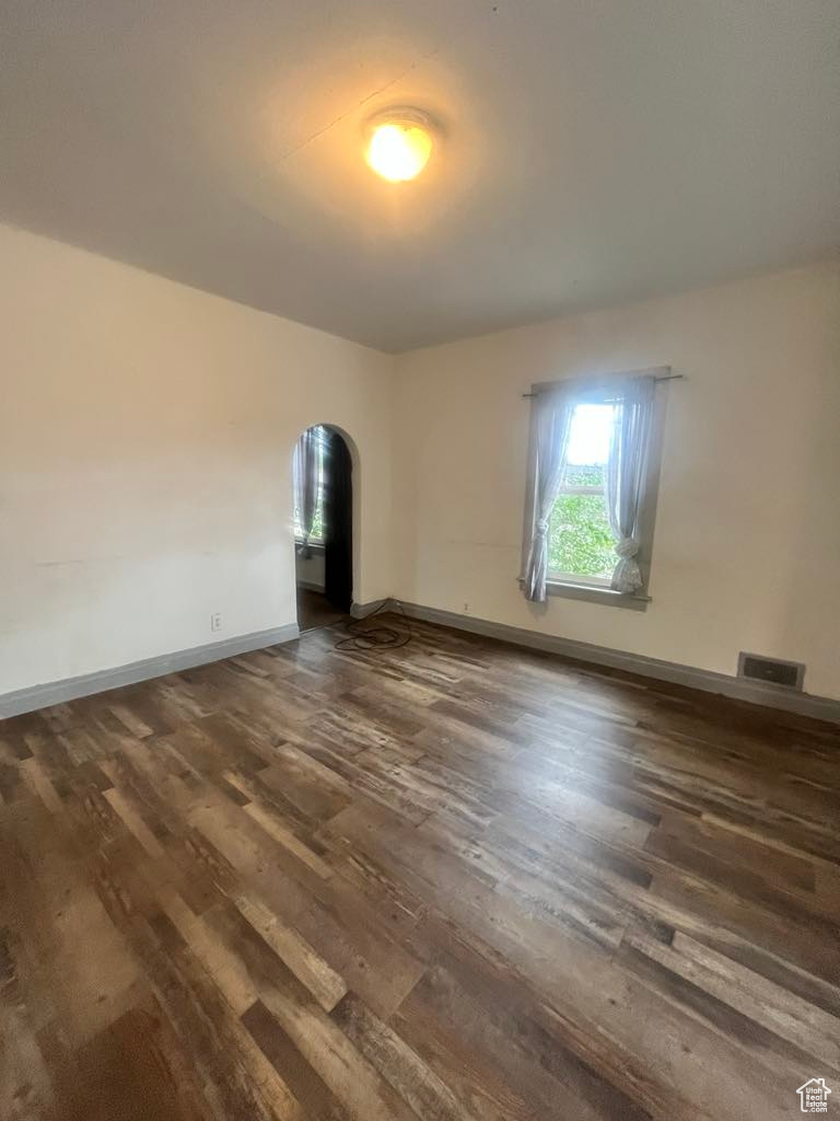 Unfurnished room featuring dark hardwood / wood-style floors