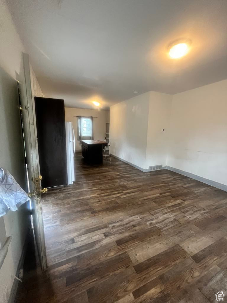 Empty room with dark hardwood / wood-style floors