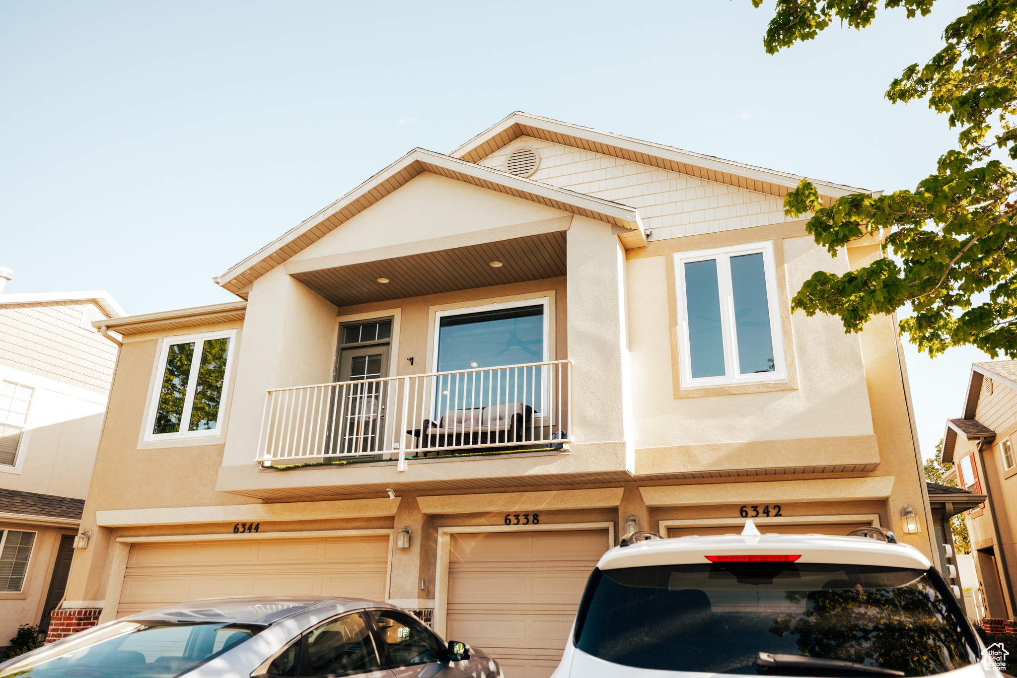 Townhome / multi-family property featuring a garage and a balcony