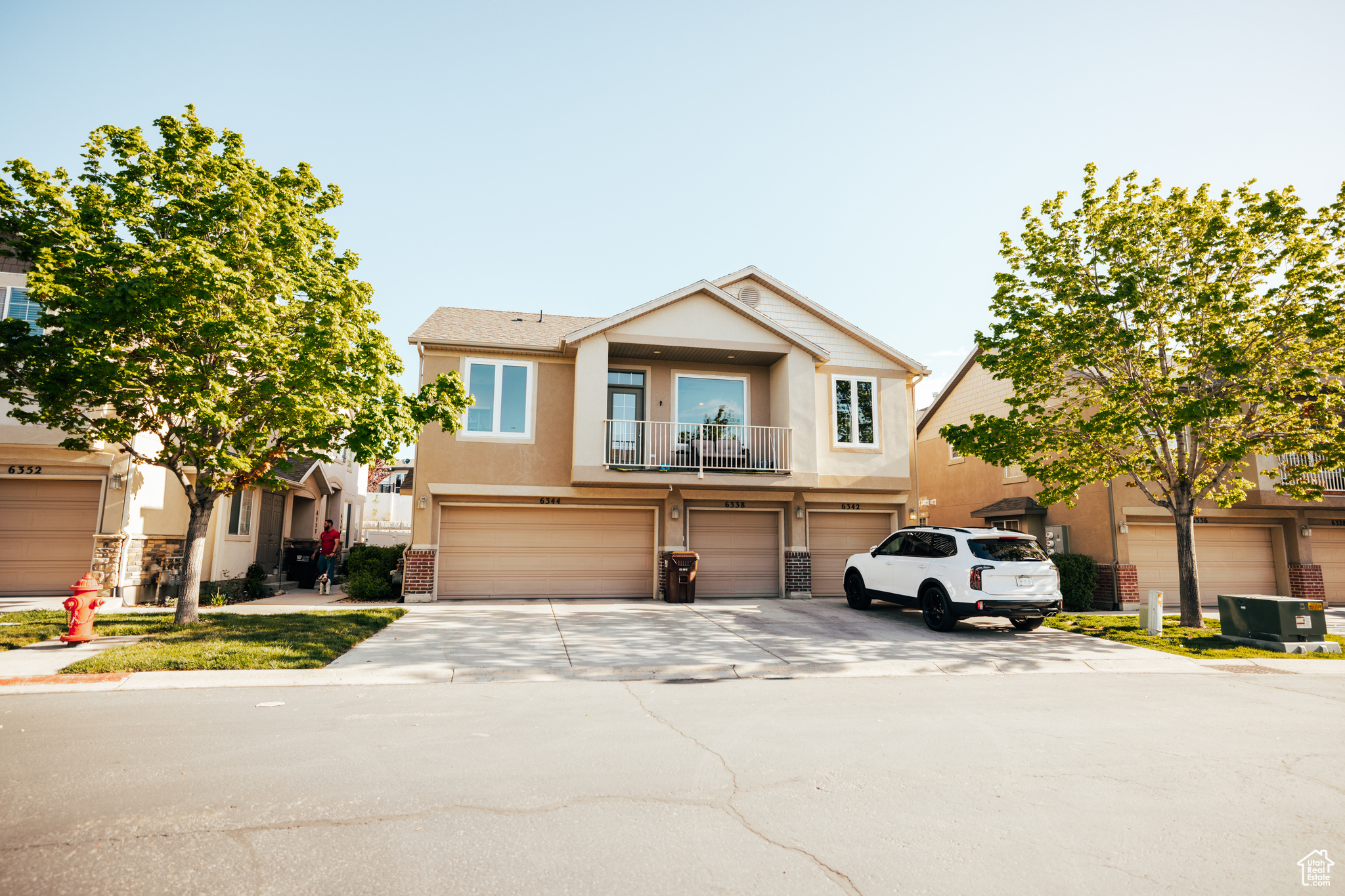 View of front facade featuring a balcony and a garage