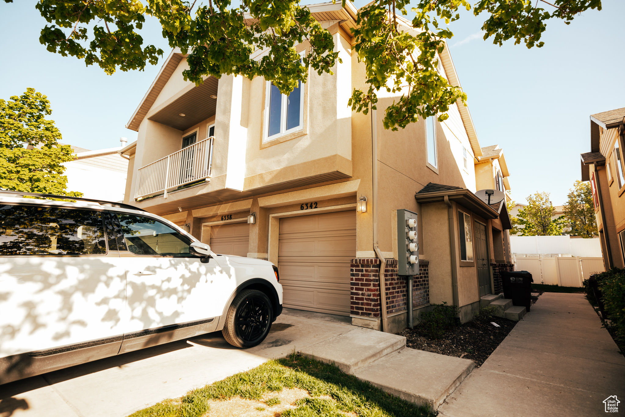 View of home's exterior featuring a balcony and a garage