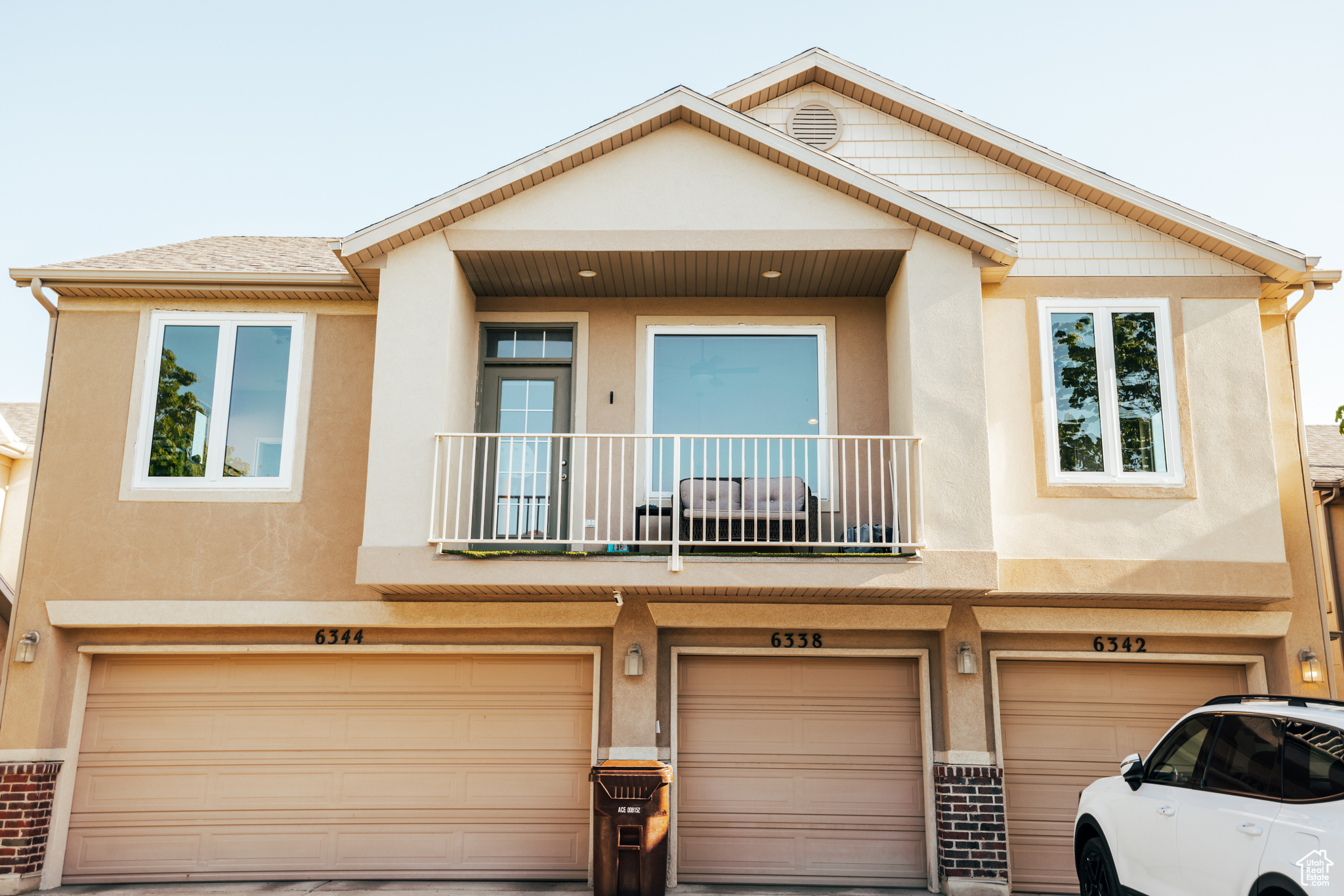 Multi unit property with a balcony and a garage