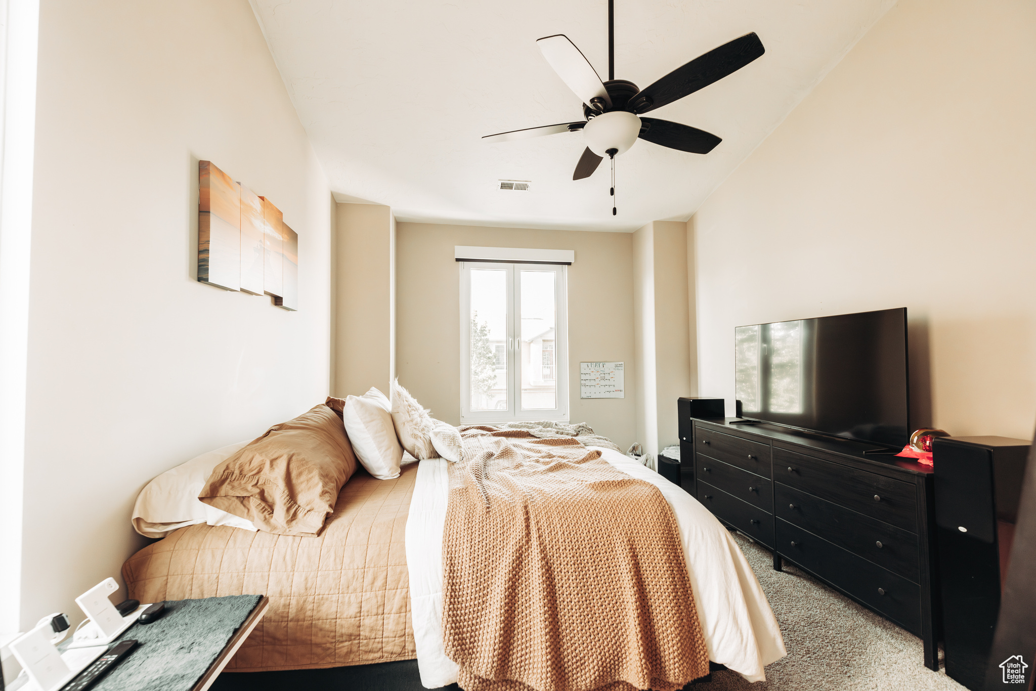 Carpeted bedroom with ceiling fan