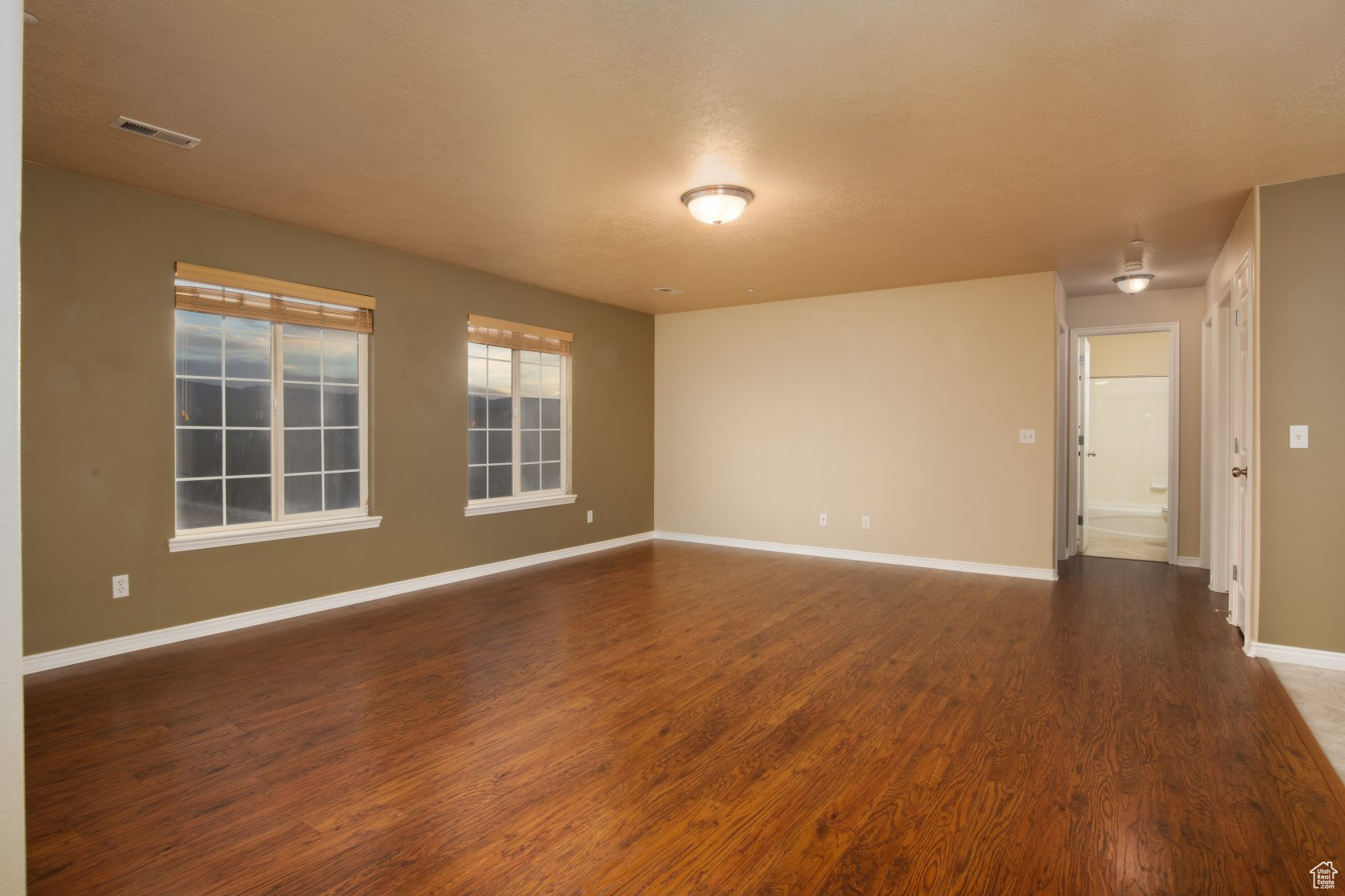 Unfurnished room with dark wood-type flooring