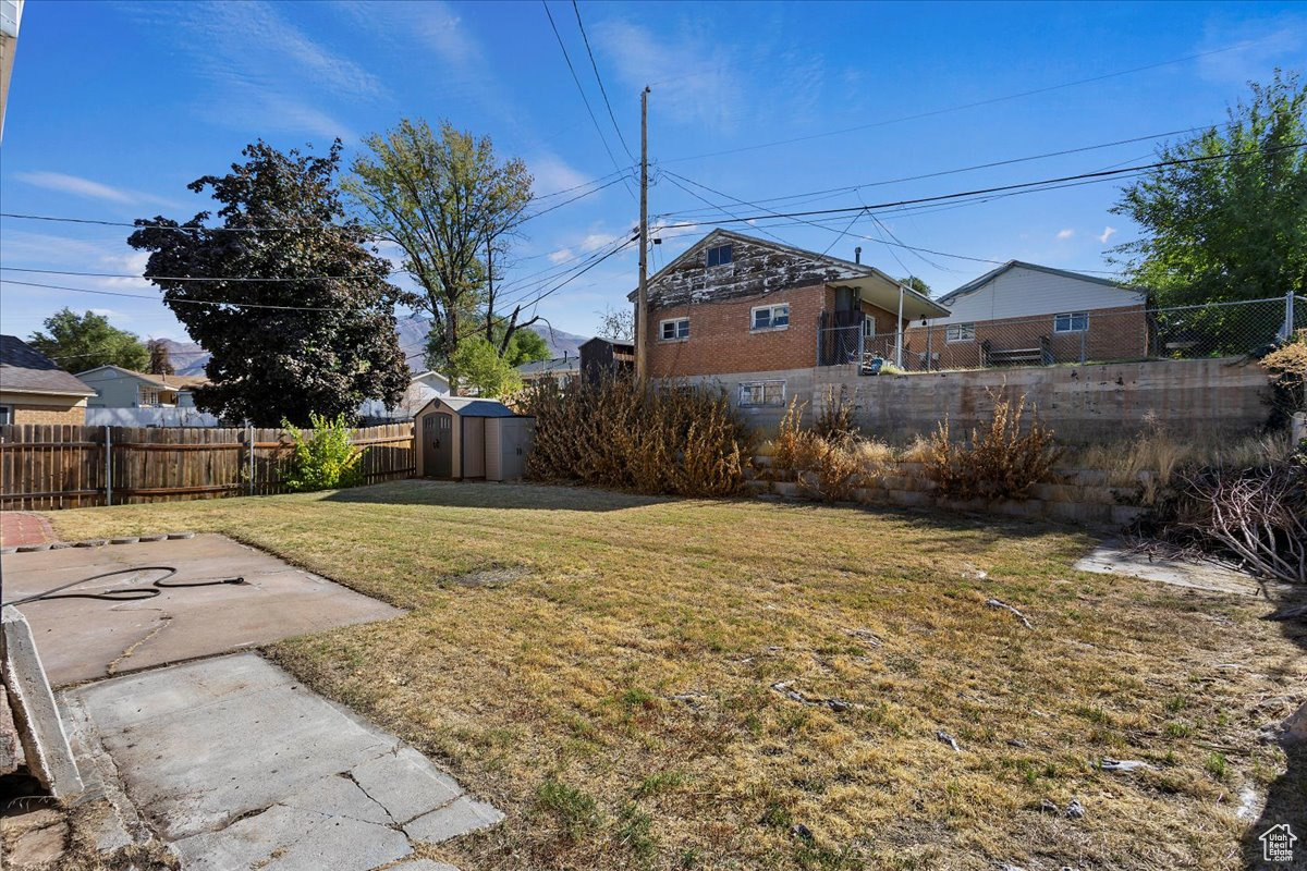 View of yard with a storage unit