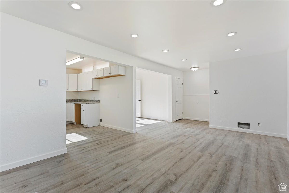 Unfurnished living room with light wood-type flooring