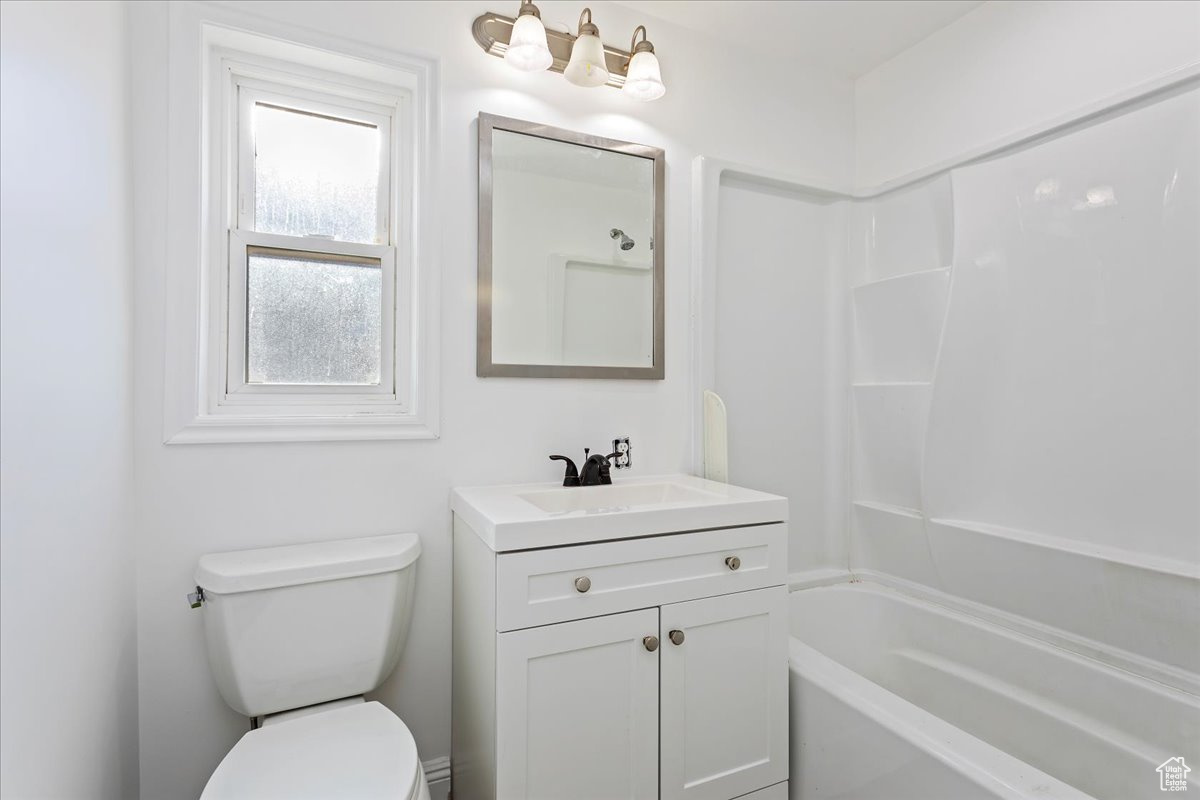 Full bathroom featuring vanity, toilet, and shower / bathtub combination