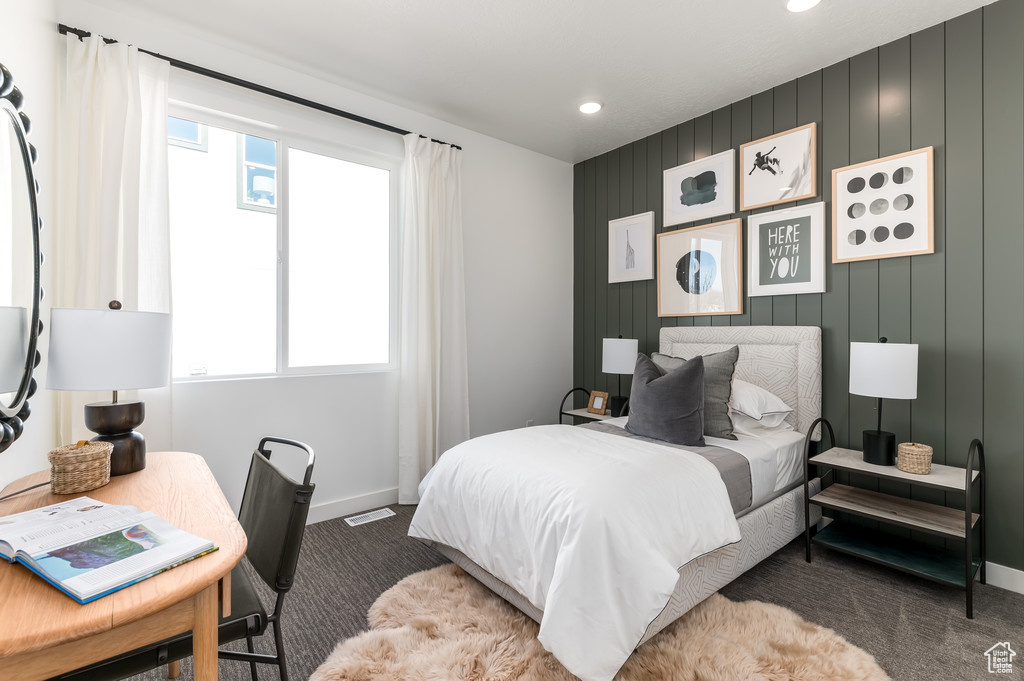 Bedroom featuring carpet and multiple windows