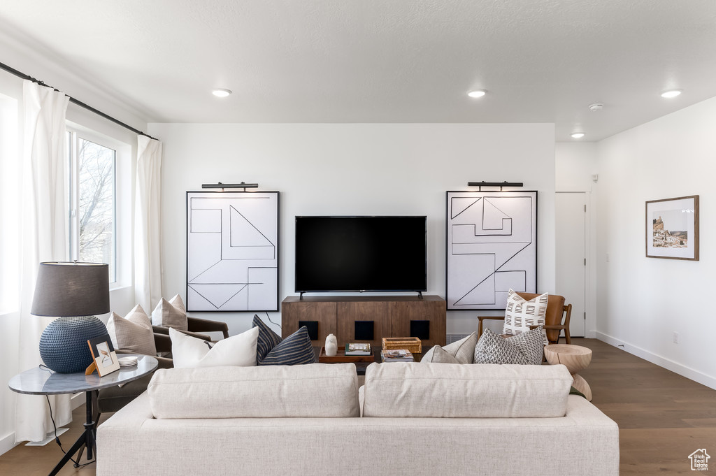 Living room with hardwood / wood-style flooring