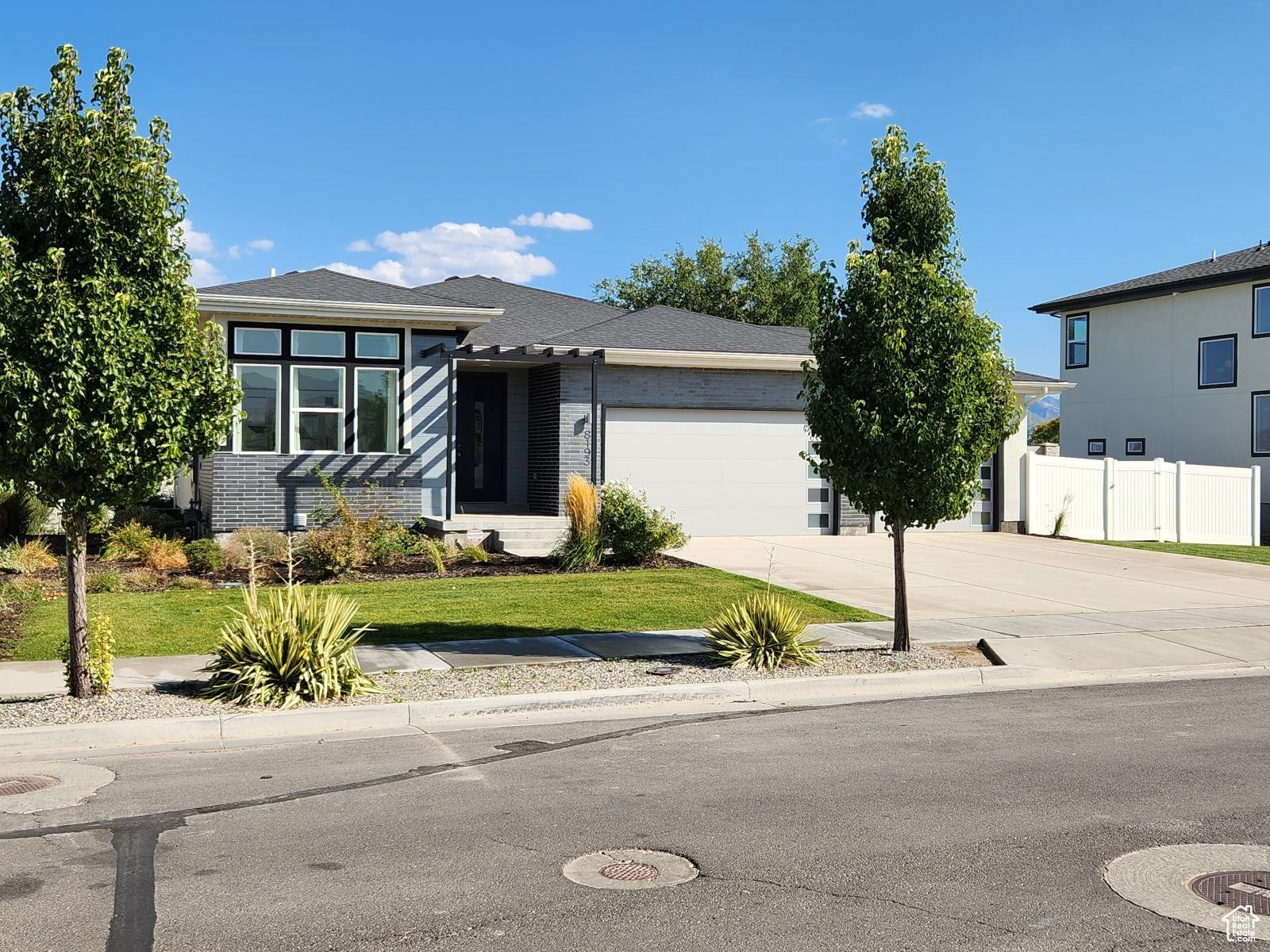 View of front facade with a front yard and a garage