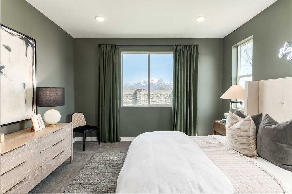 Bedroom featuring dark colored carpet