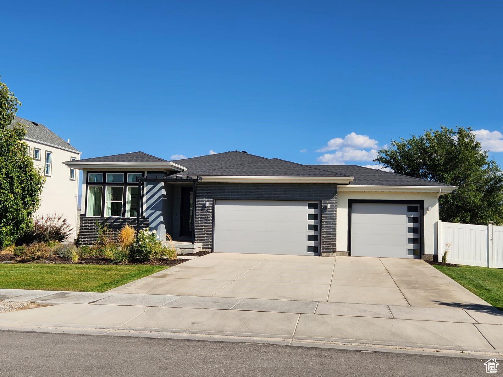 Prairie-style house featuring a garage and a front lawn