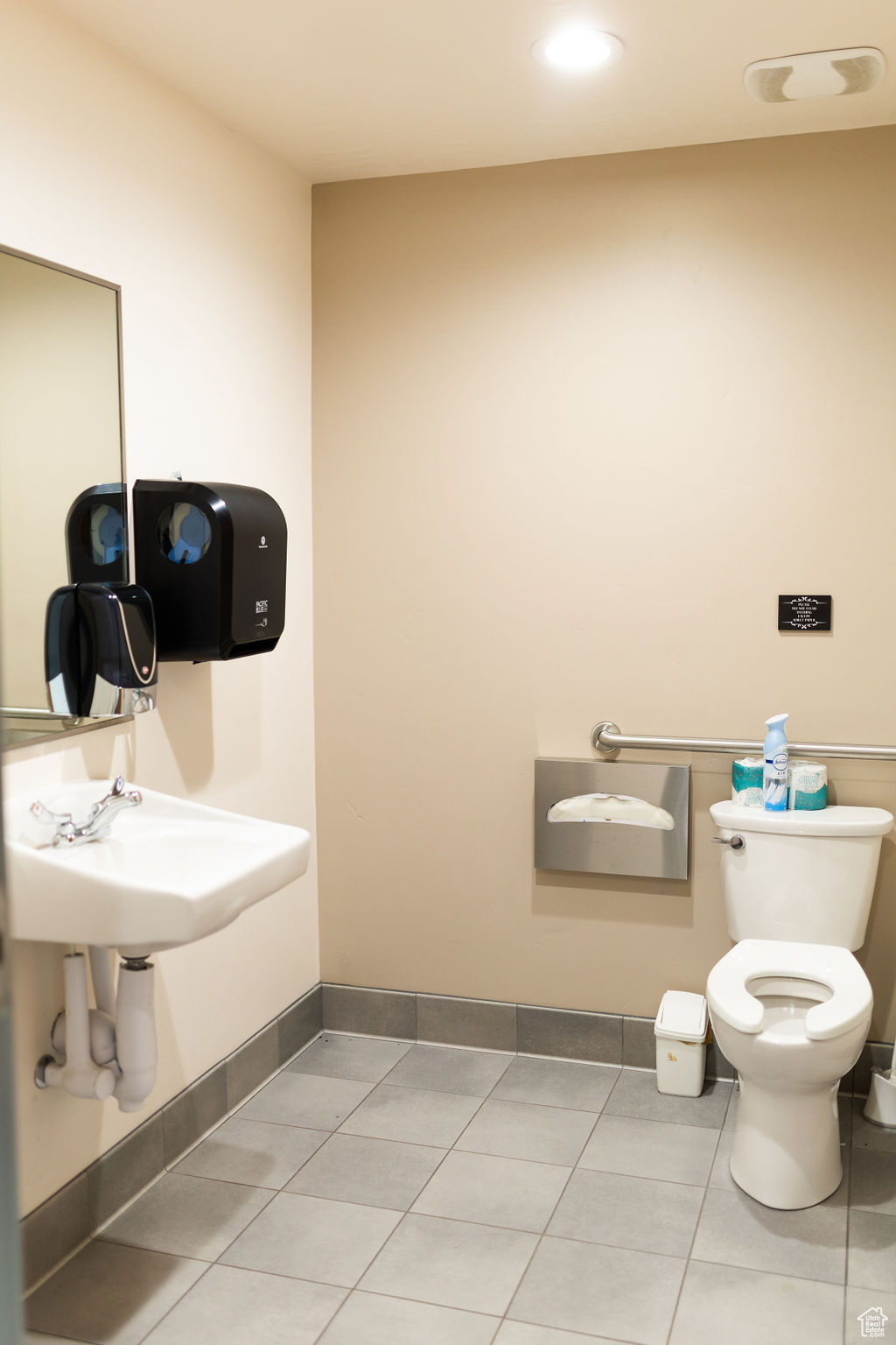 Bathroom featuring toilet and tile patterned flooring