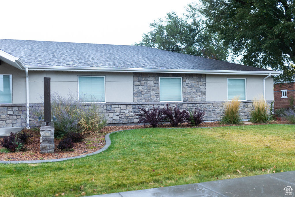 View of side of home featuring a lawn