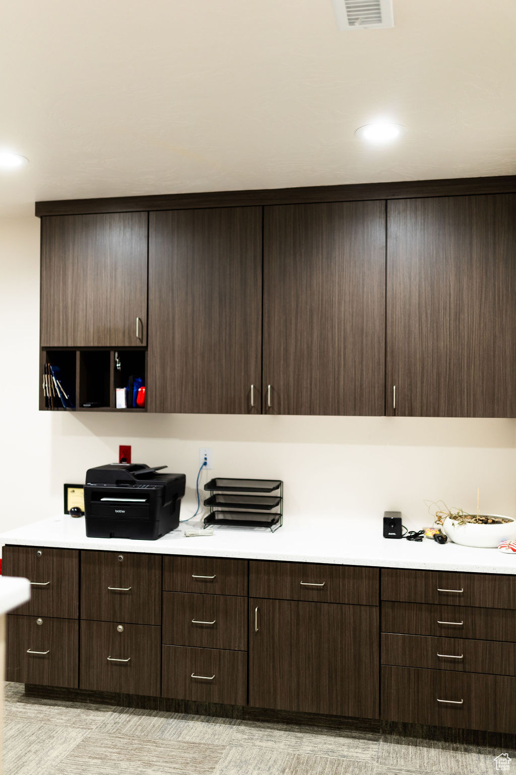 Kitchen featuring dark brown cabinetry