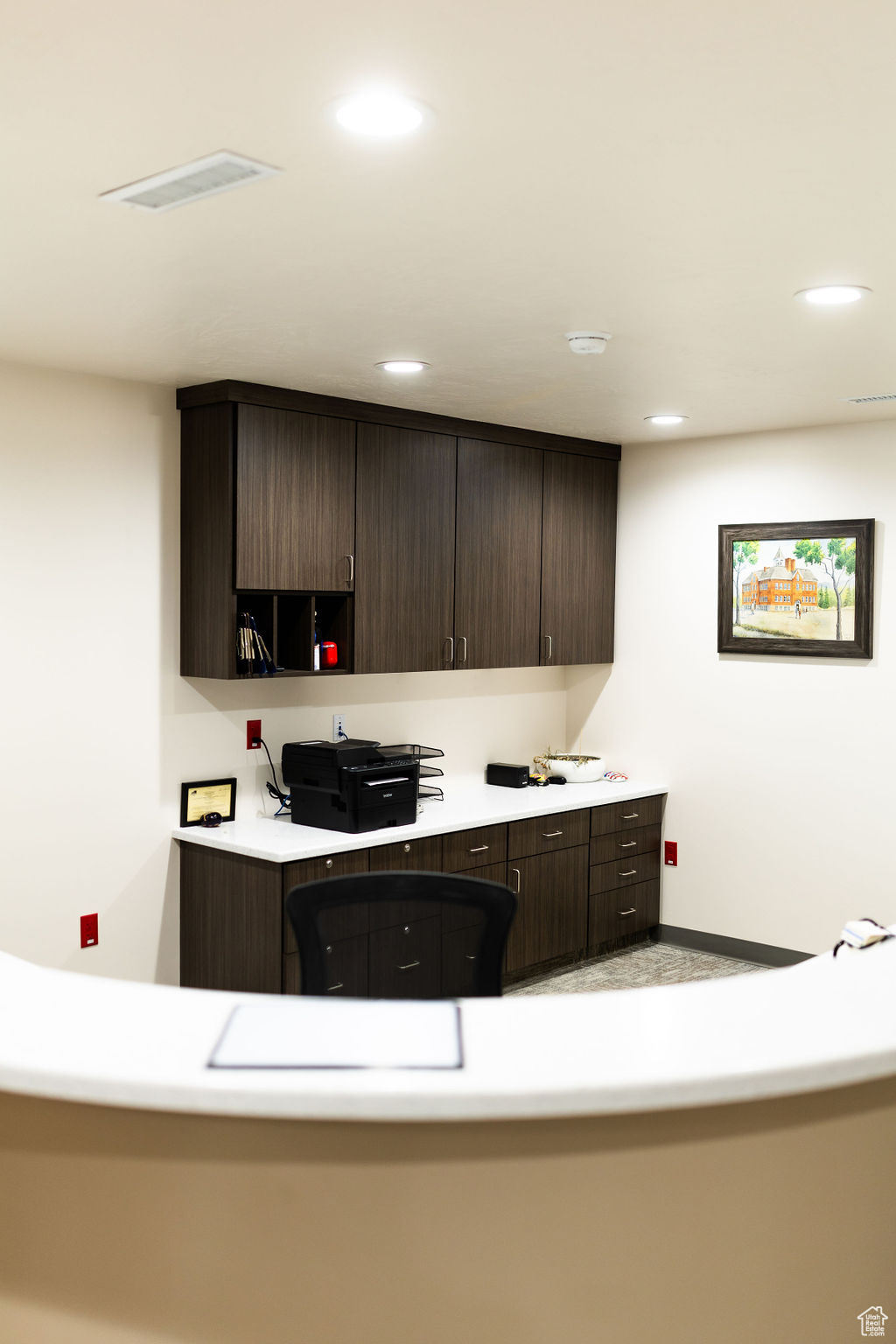 Kitchen featuring dark brown cabinets