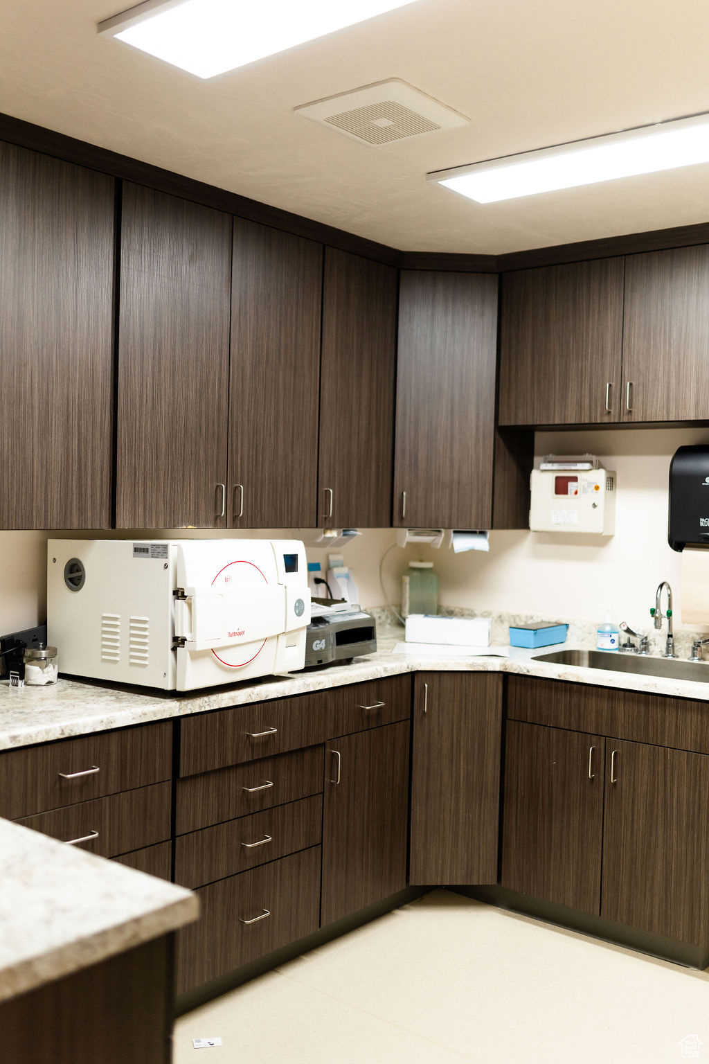 Kitchen with sink and dark brown cabinets