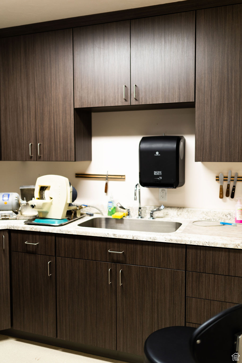 Kitchen featuring sink and dark brown cabinets