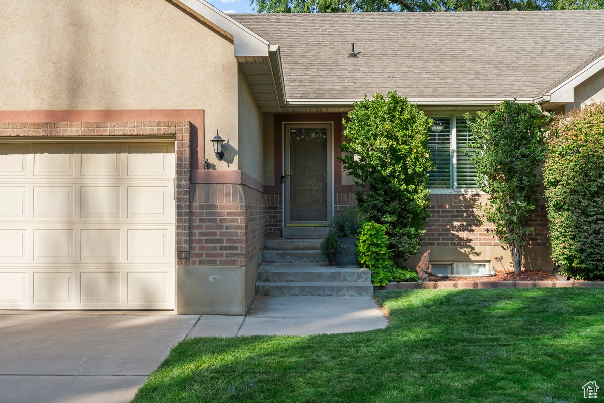 Entrance to property featuring a lawn