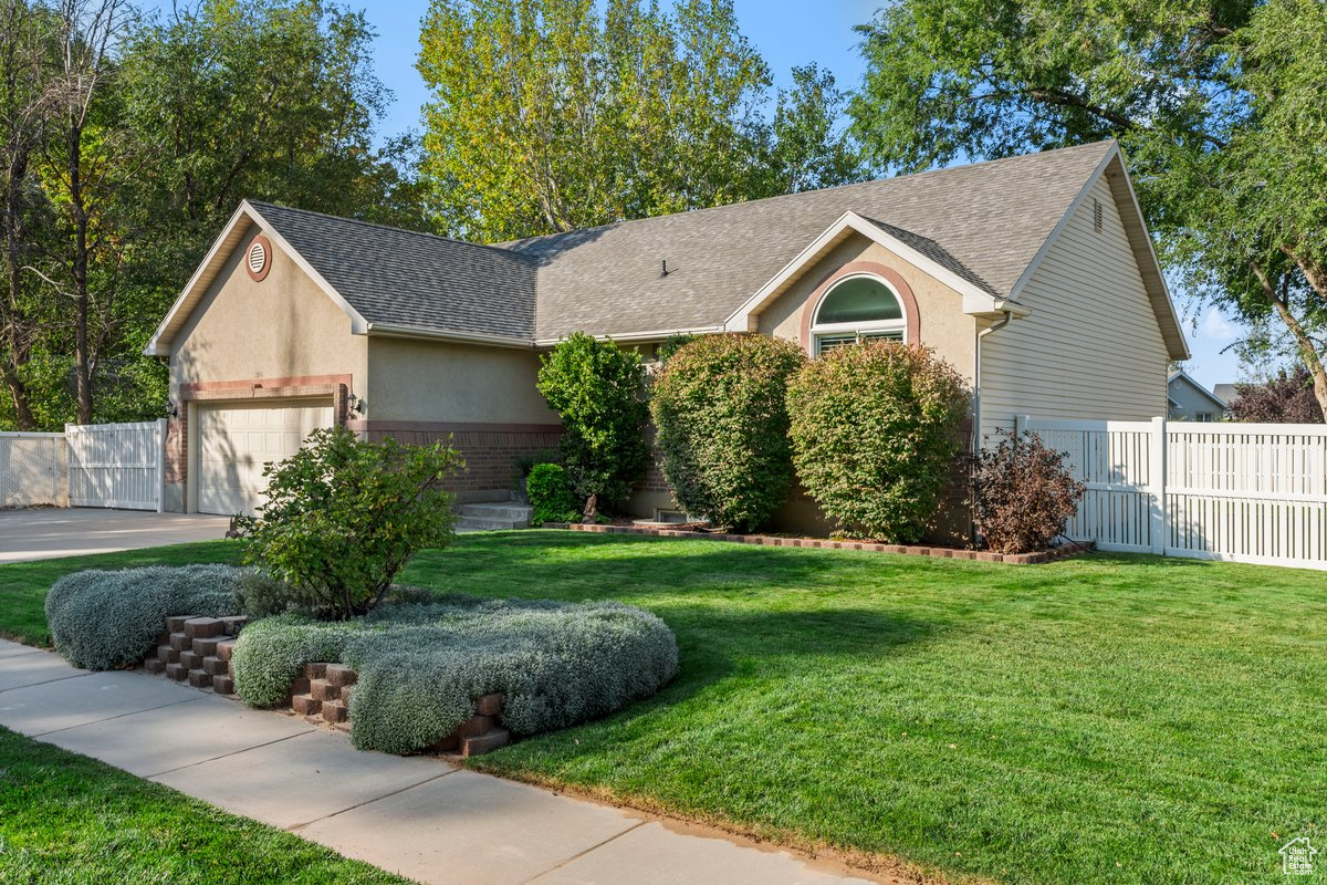 Ranch-style house with a garage and a front yard