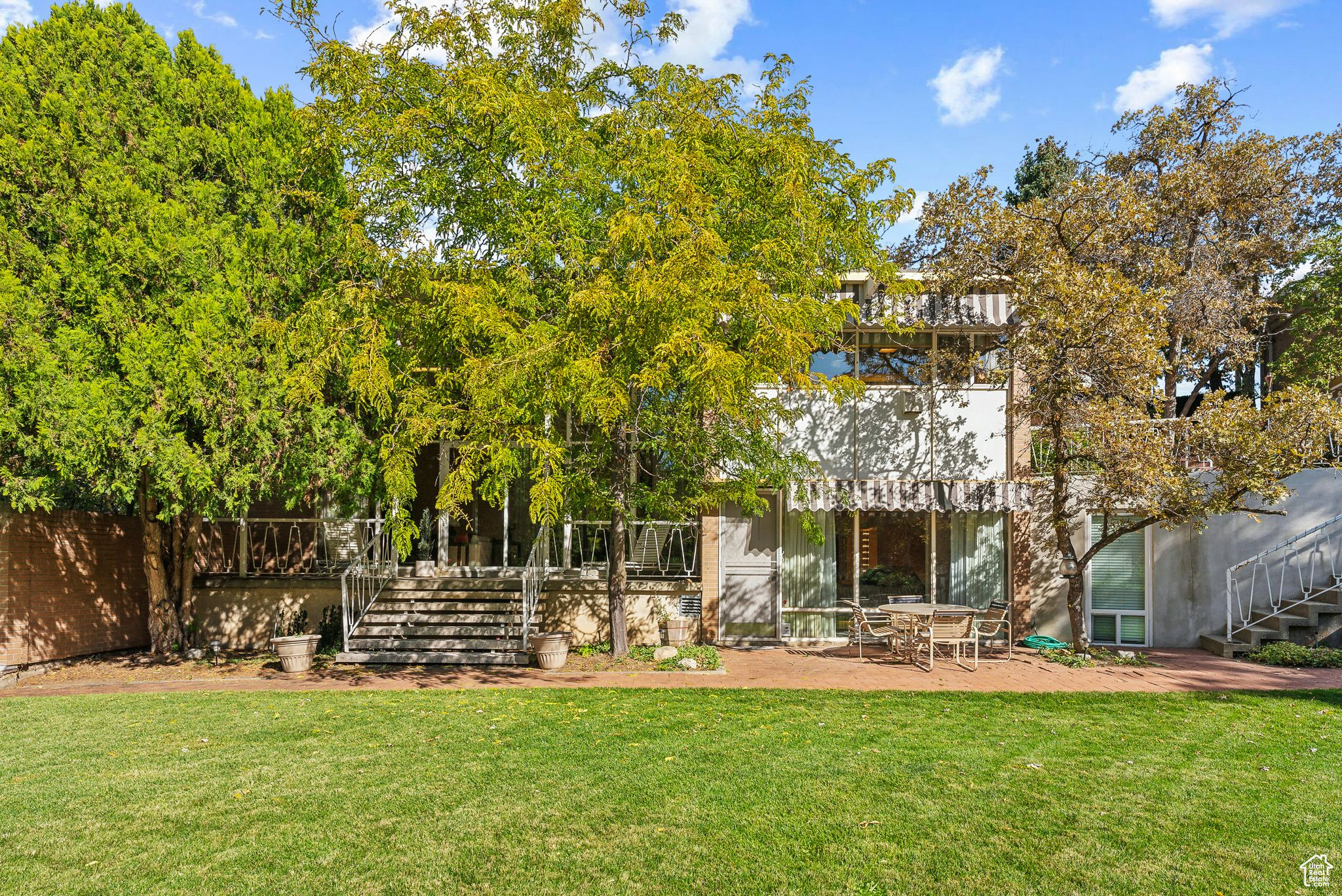 Rear view of property featuring a yard and a patio