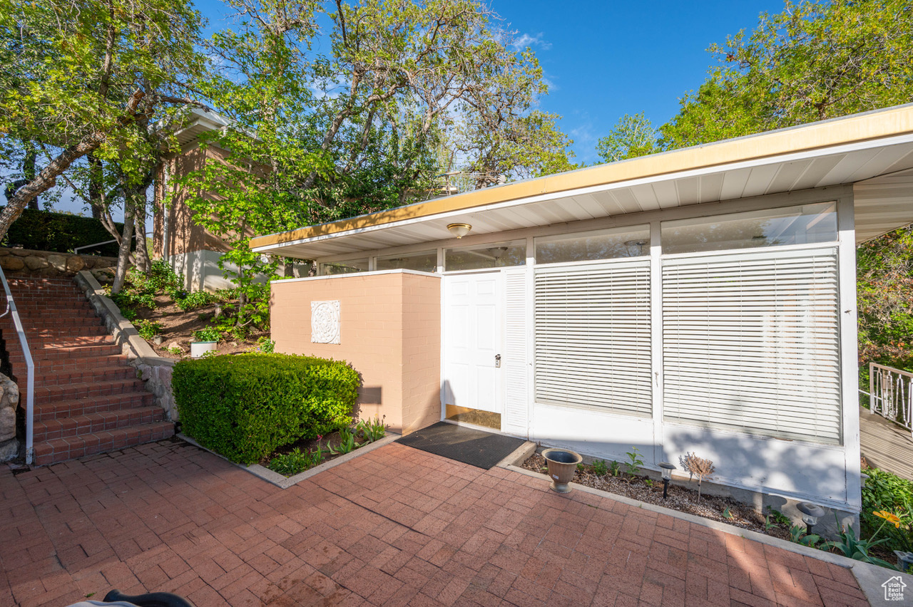 View of exterior entry to guest house with a patio area