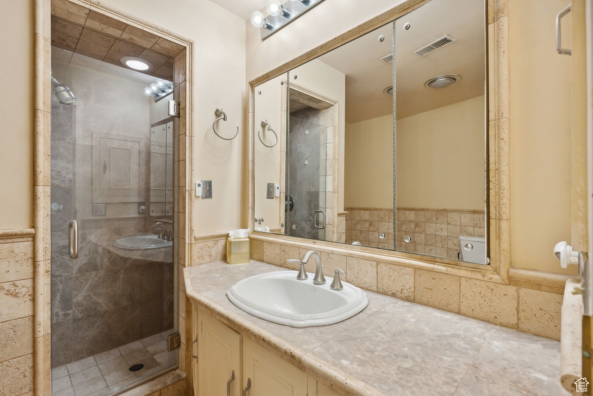 Bathroom with vanity and an enclosed shower