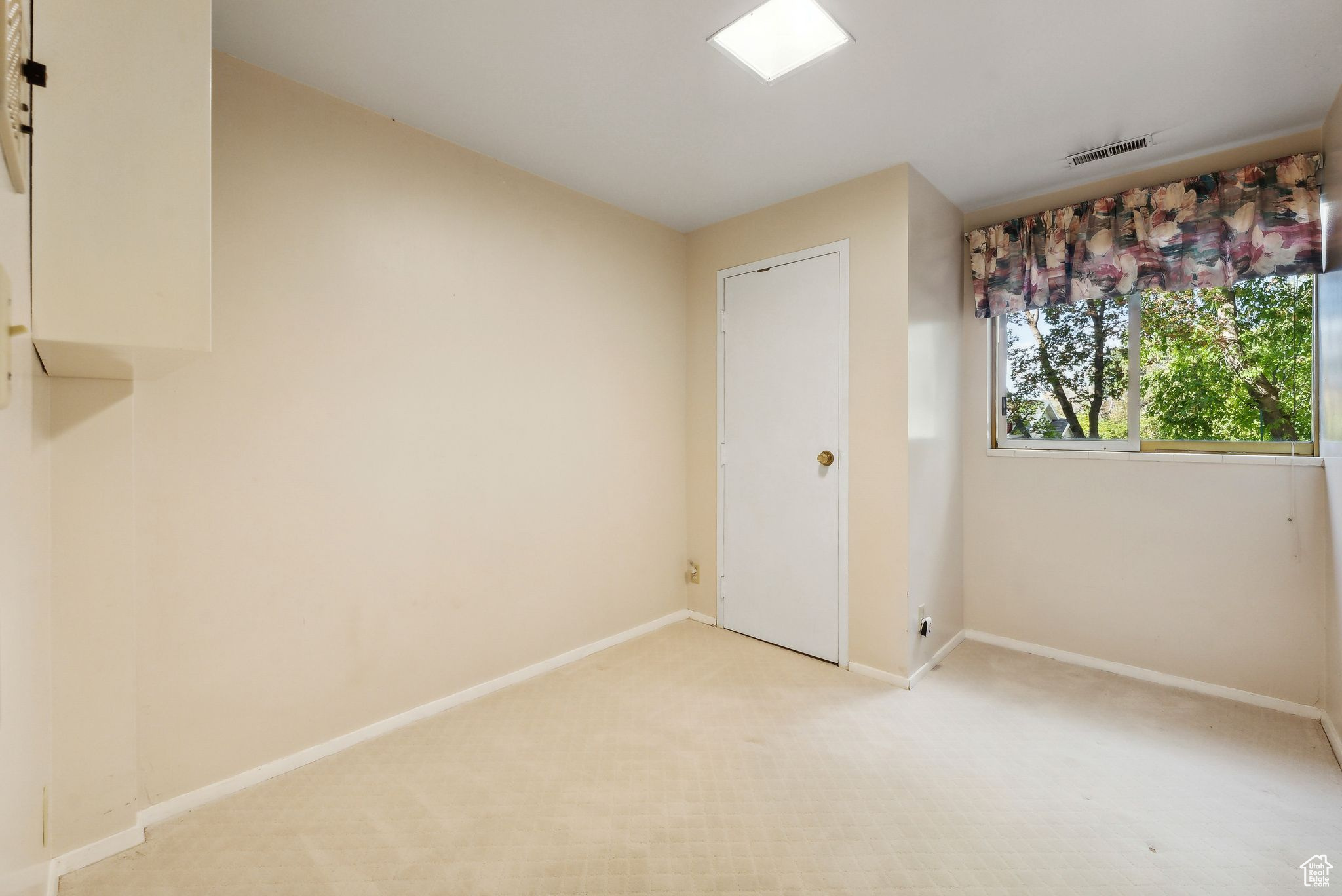 Unfurnished bedroom with light colored carpet