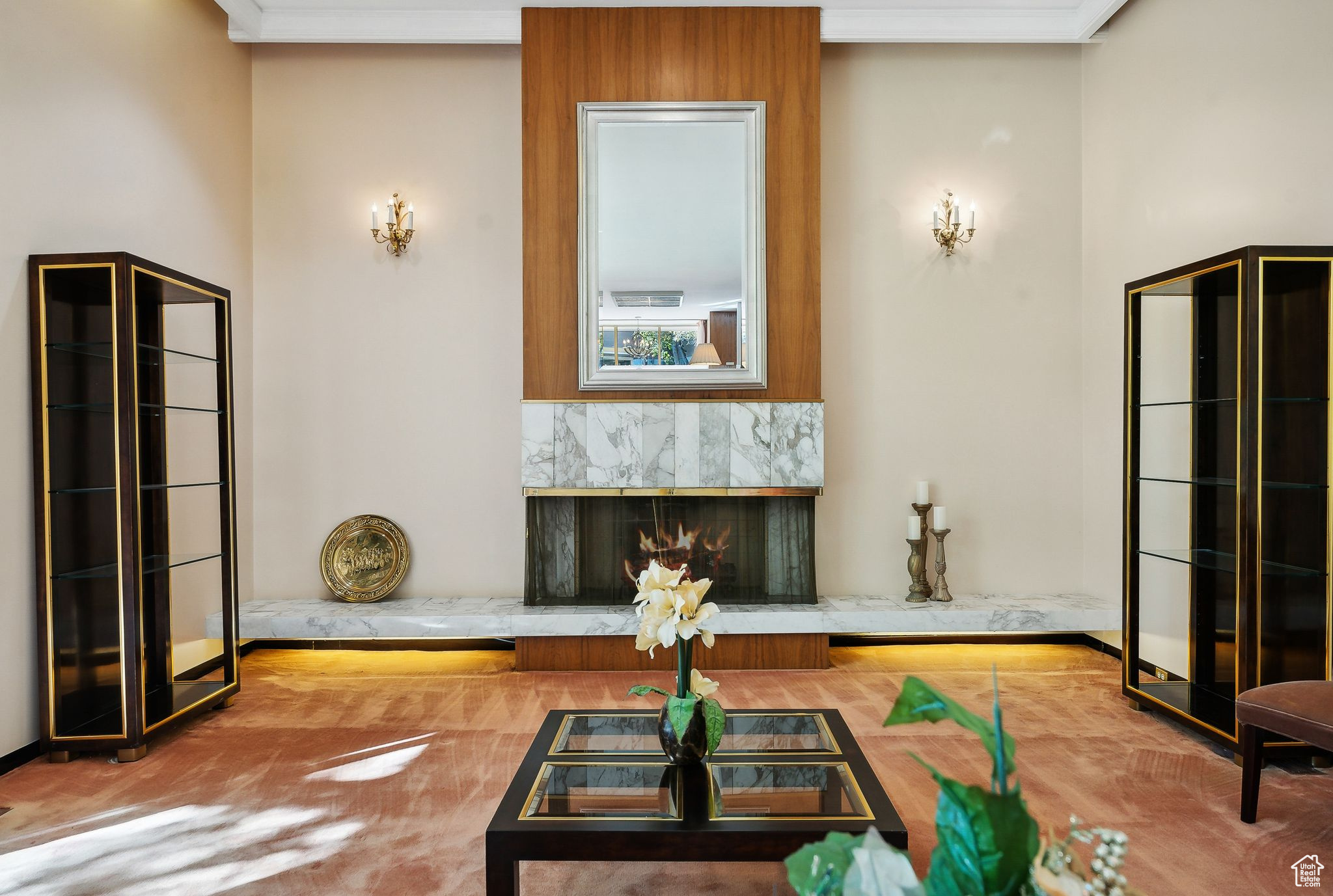 Interior space featuring crown molding, hardwood / wood-style flooring, and a high end fireplace