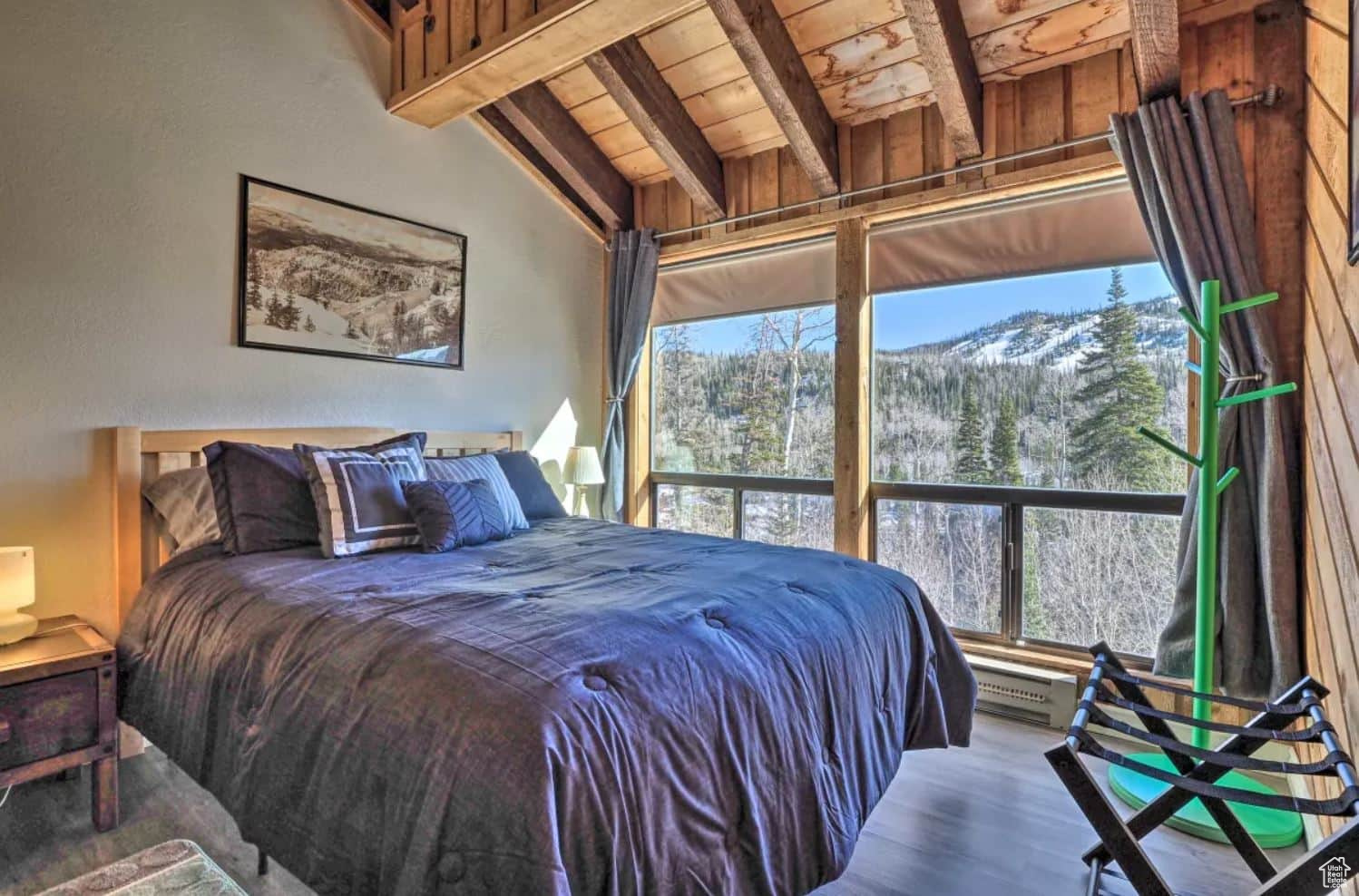 Bedroom with lofted ceiling with beams, a mountain view, hardwood / wood-style floors, and wooden ceiling