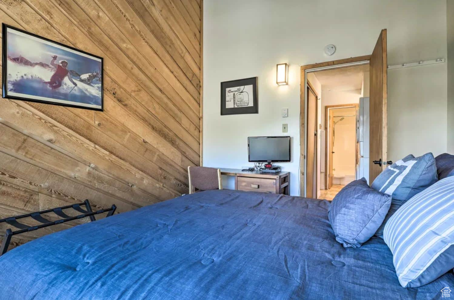 Bedroom featuring wood walls