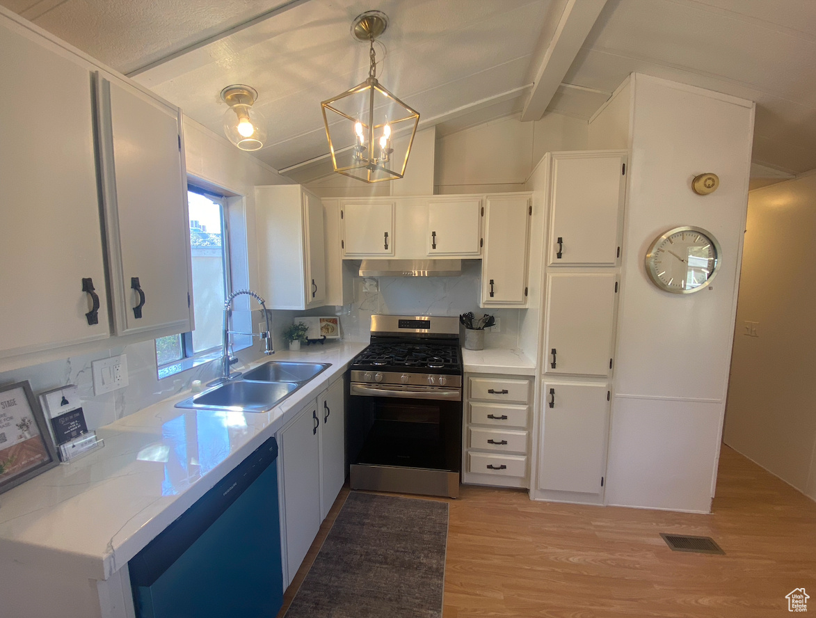 Kitchen featuring decorative backsplash, lofted ceiling with beams, decorative light fixtures, stainless steel appliances, and white cabinetry