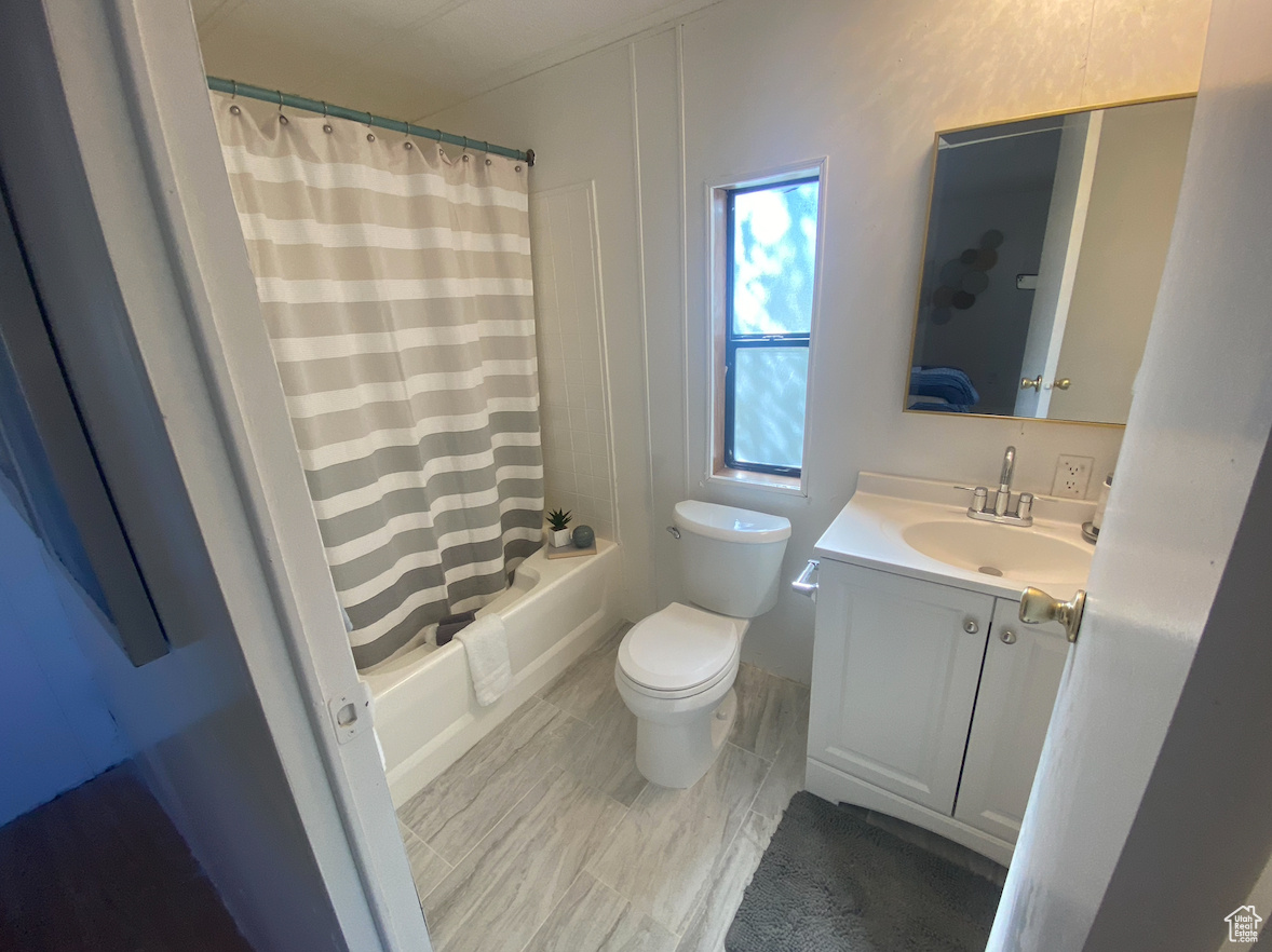 Full bathroom with vanity, toilet, and shower / bath combo