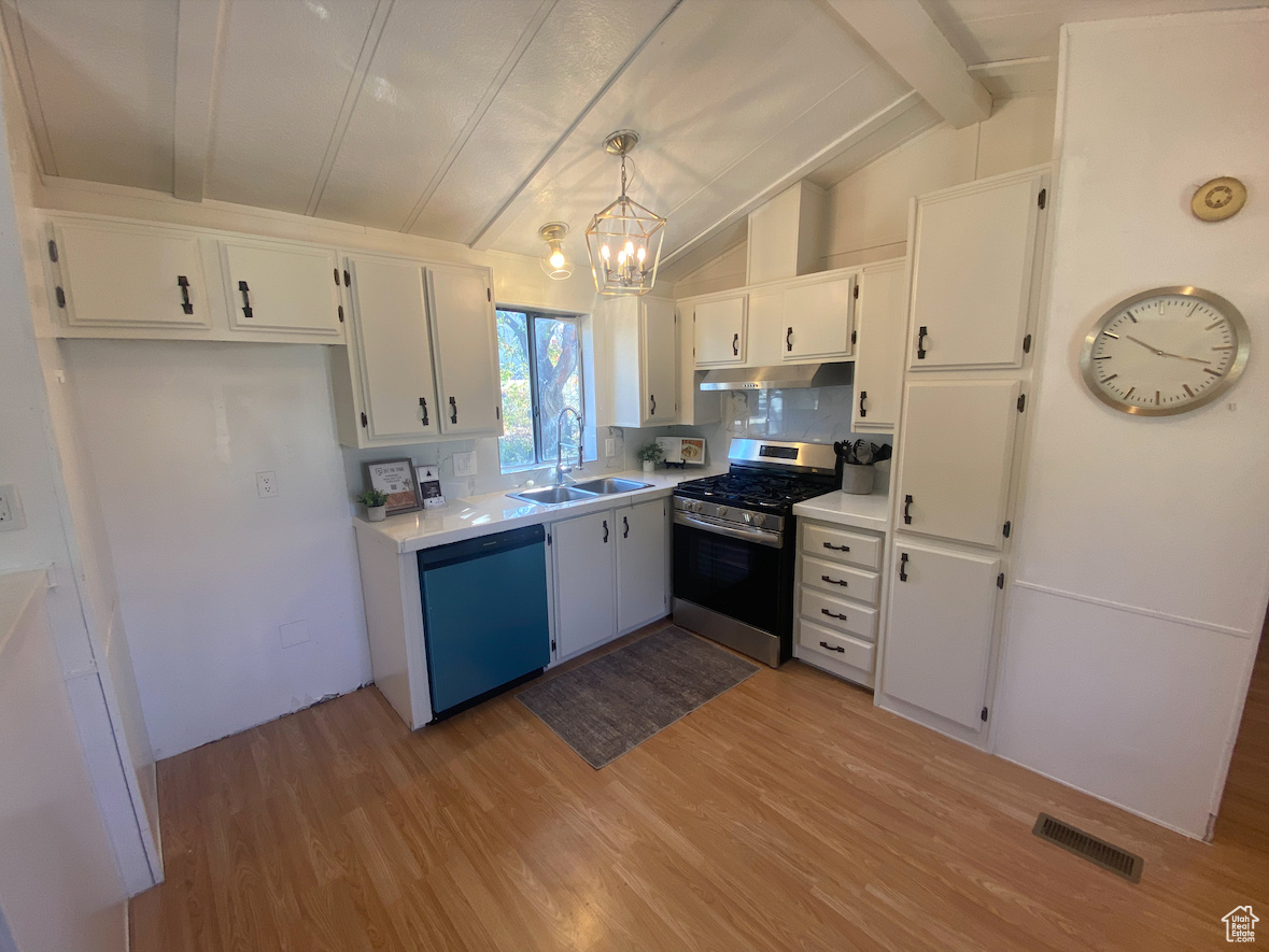 Kitchen featuring lofted ceiling with beams, pendant lighting, sink, stainless steel appliances, and white cabinets