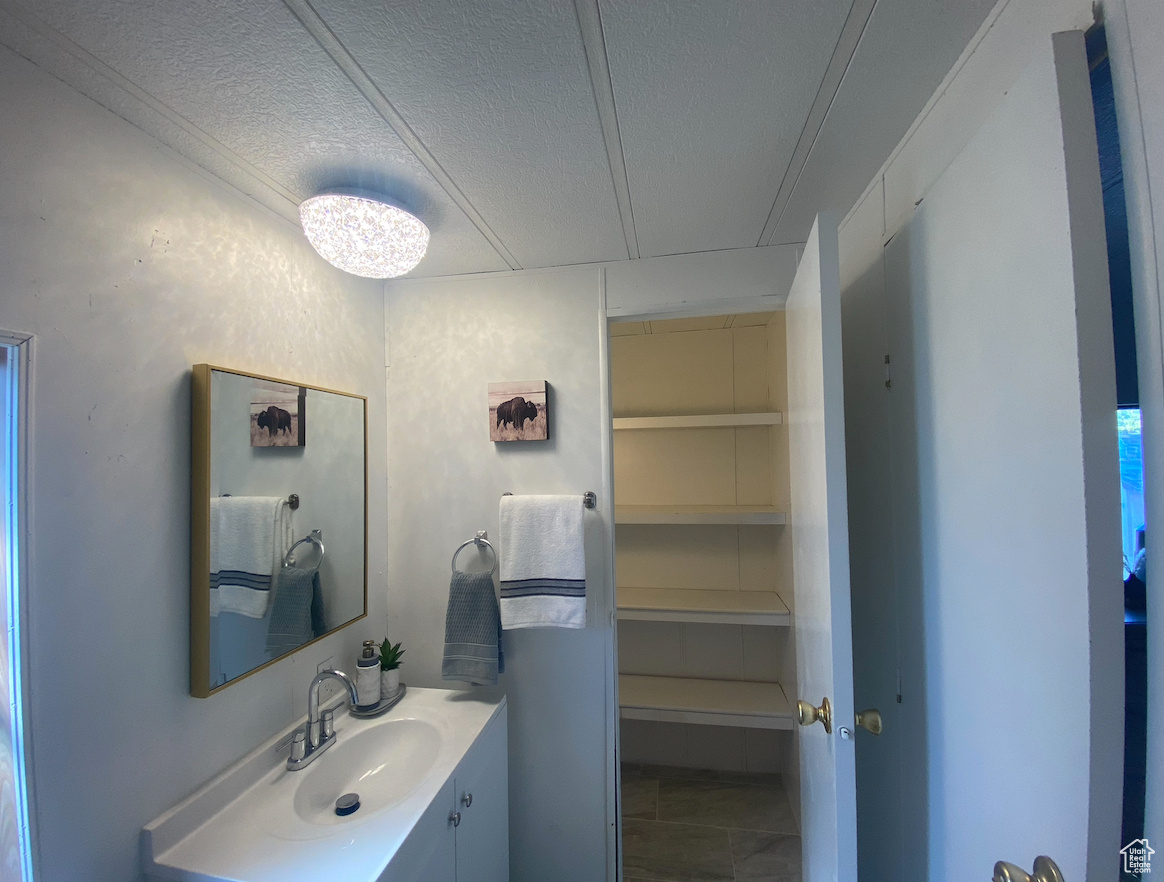 Bathroom with vanity and a textured ceiling