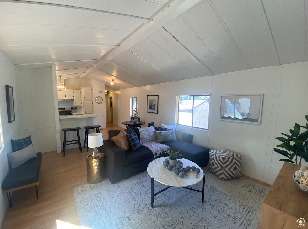 Living room featuring light hardwood / wood-style flooring and vaulted ceiling