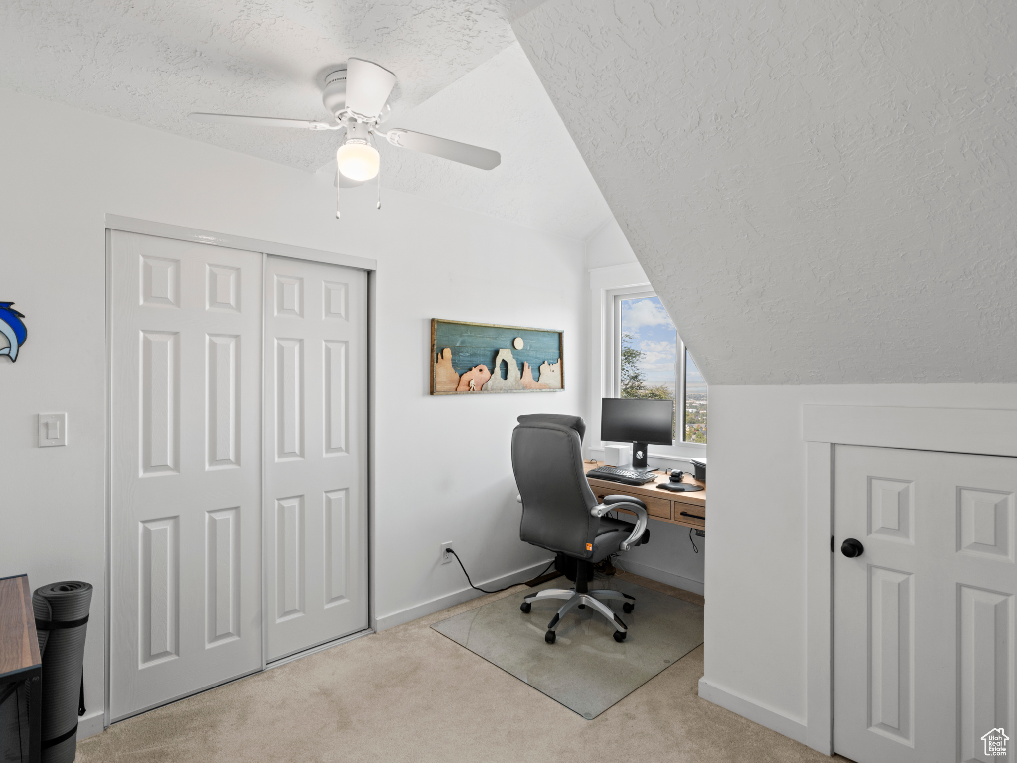 Office featuring lofted ceiling, a textured ceiling, light colored carpet, and ceiling fan