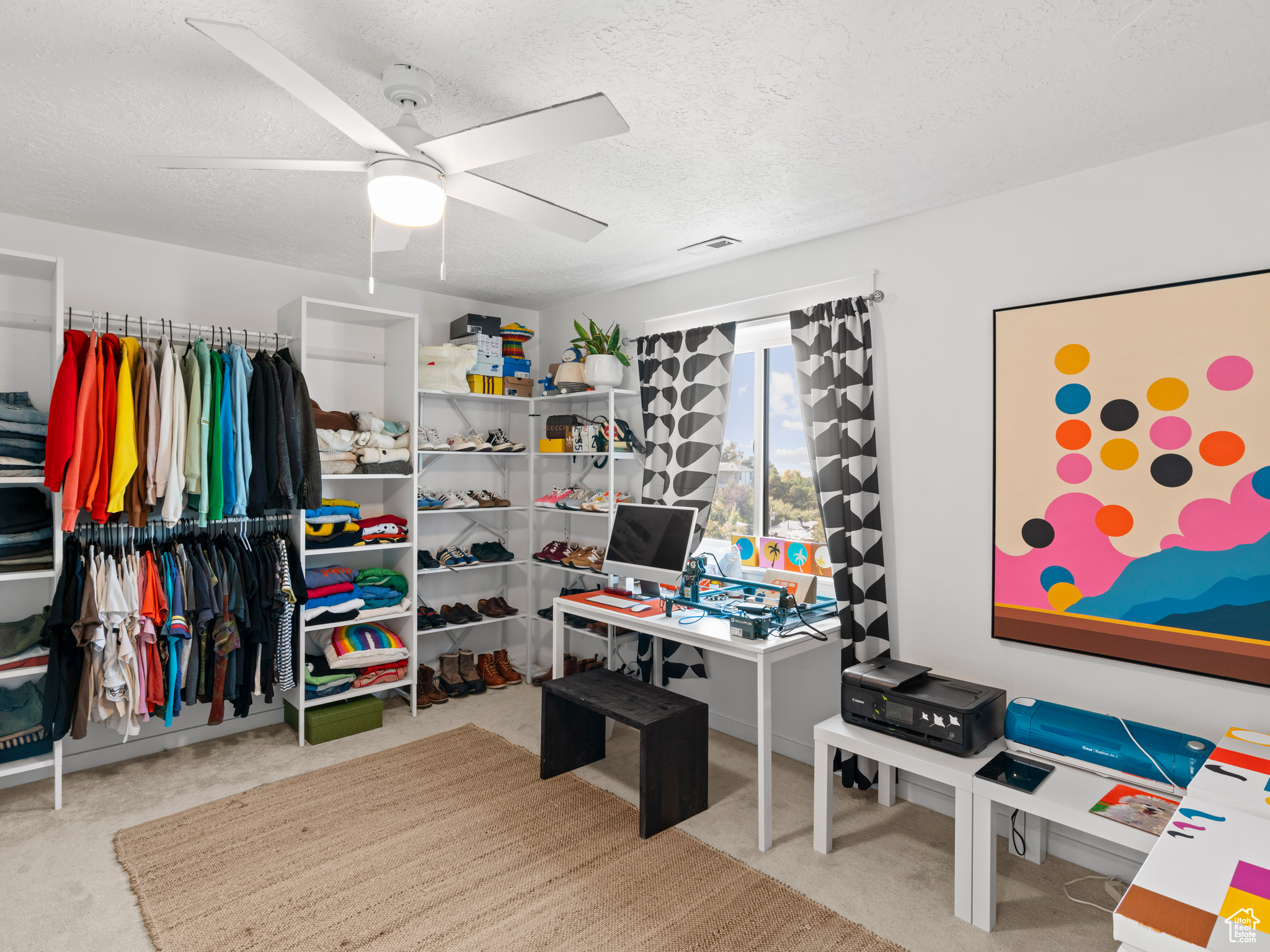 Carpeted bedroom with ceiling fan