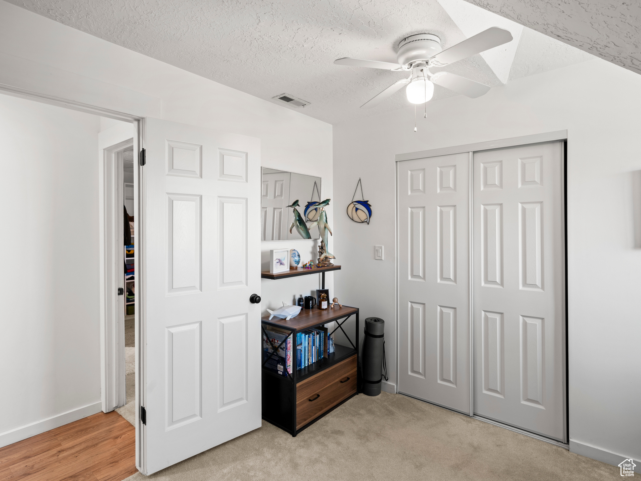 Carpeted bedroom, with a closet, and ceiling fan