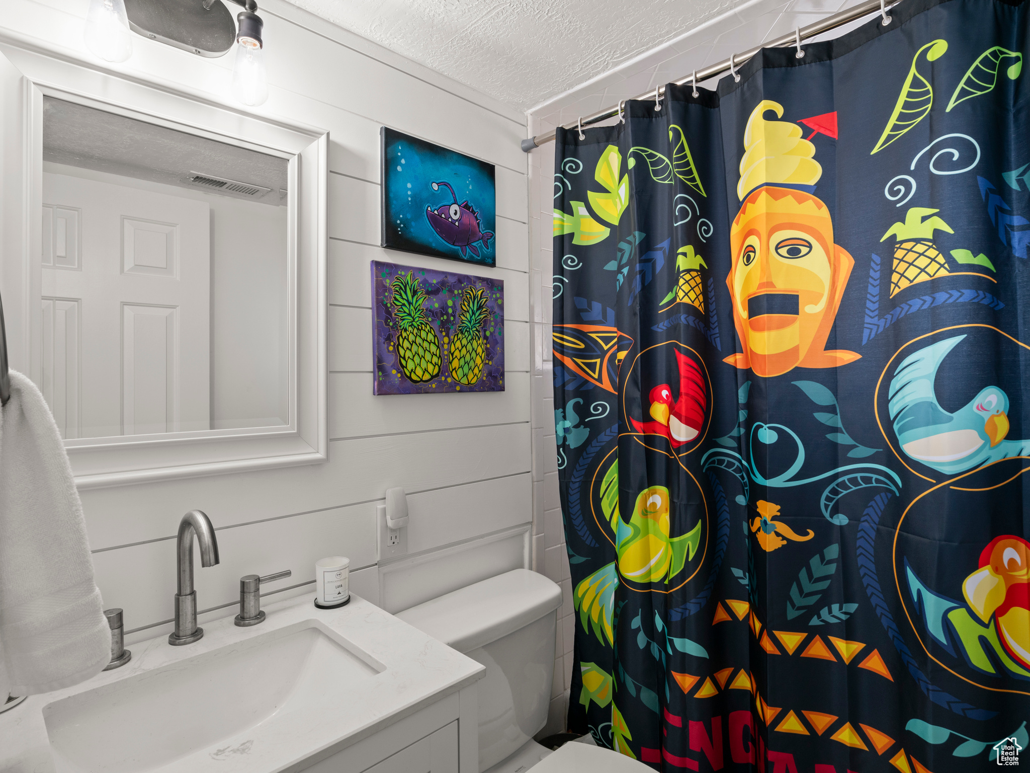 Bathroom with vanity, a shower with curtain, a textured ceiling, and toilet