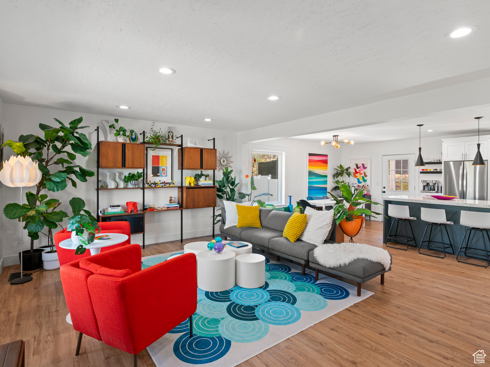 Living room with an inviting chandelier and light hardwood / wood-style floors