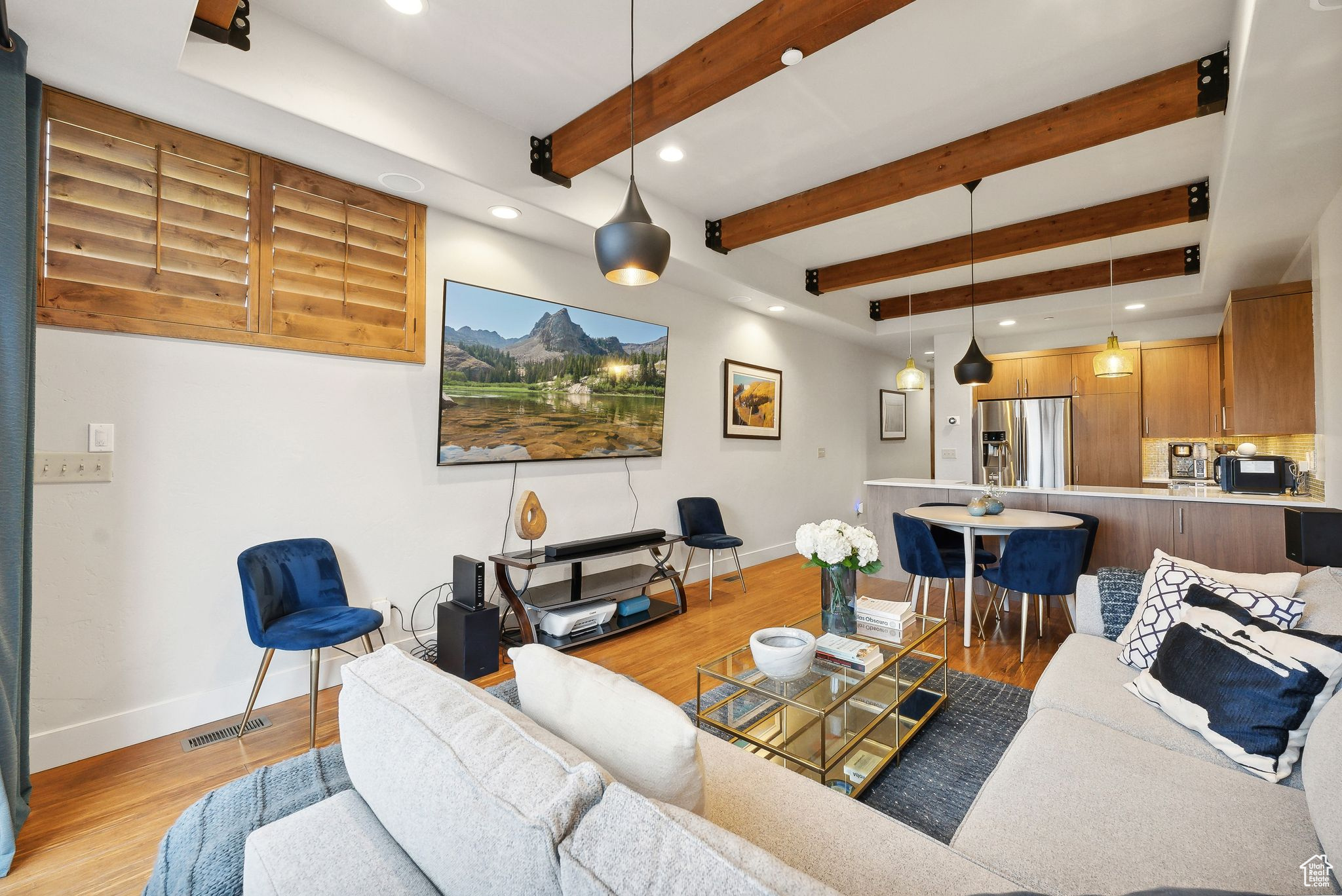 Living room with beamed ceiling and light wood-type flooring