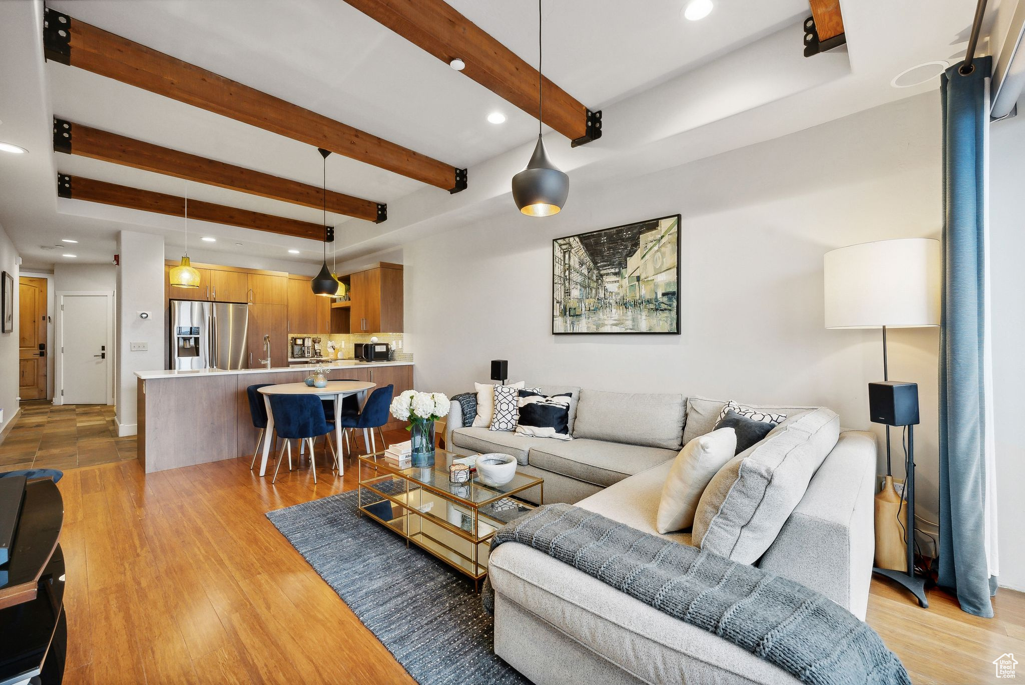 Living room with beamed ceiling and light wood-type flooring