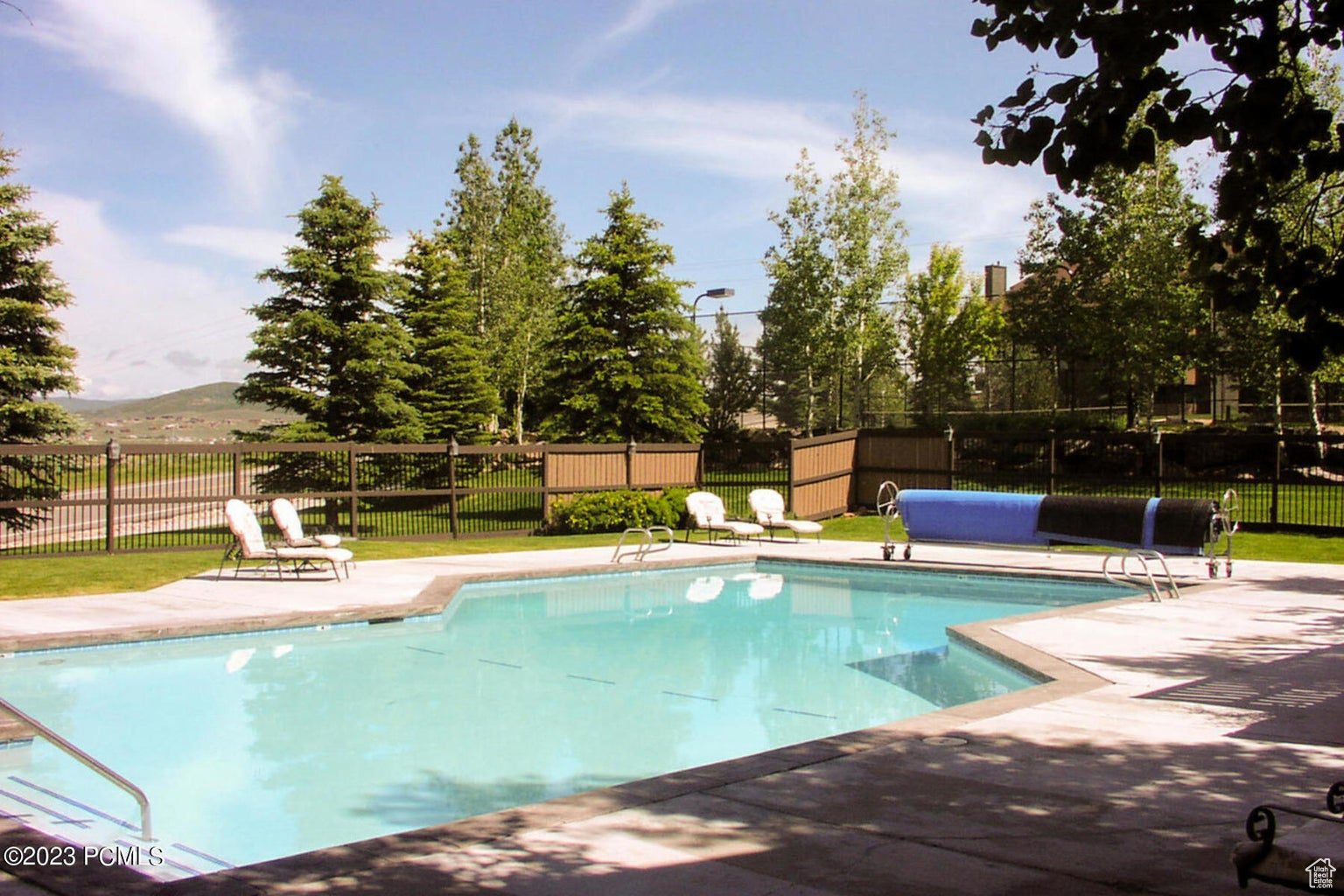 View of swimming pool with a patio area and a mountain view