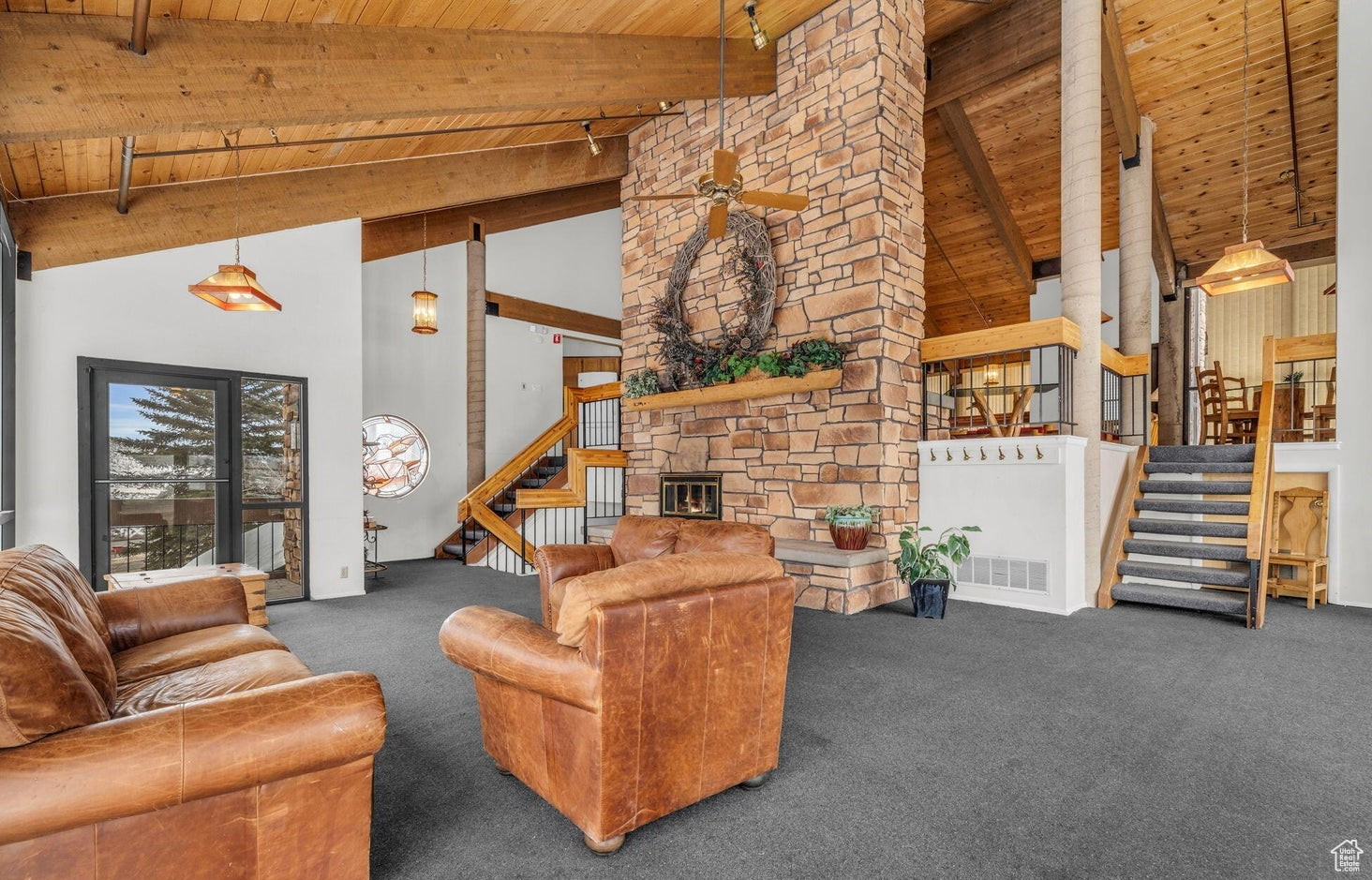 Carpeted living room featuring high vaulted ceiling, beamed ceiling, and wooden ceiling