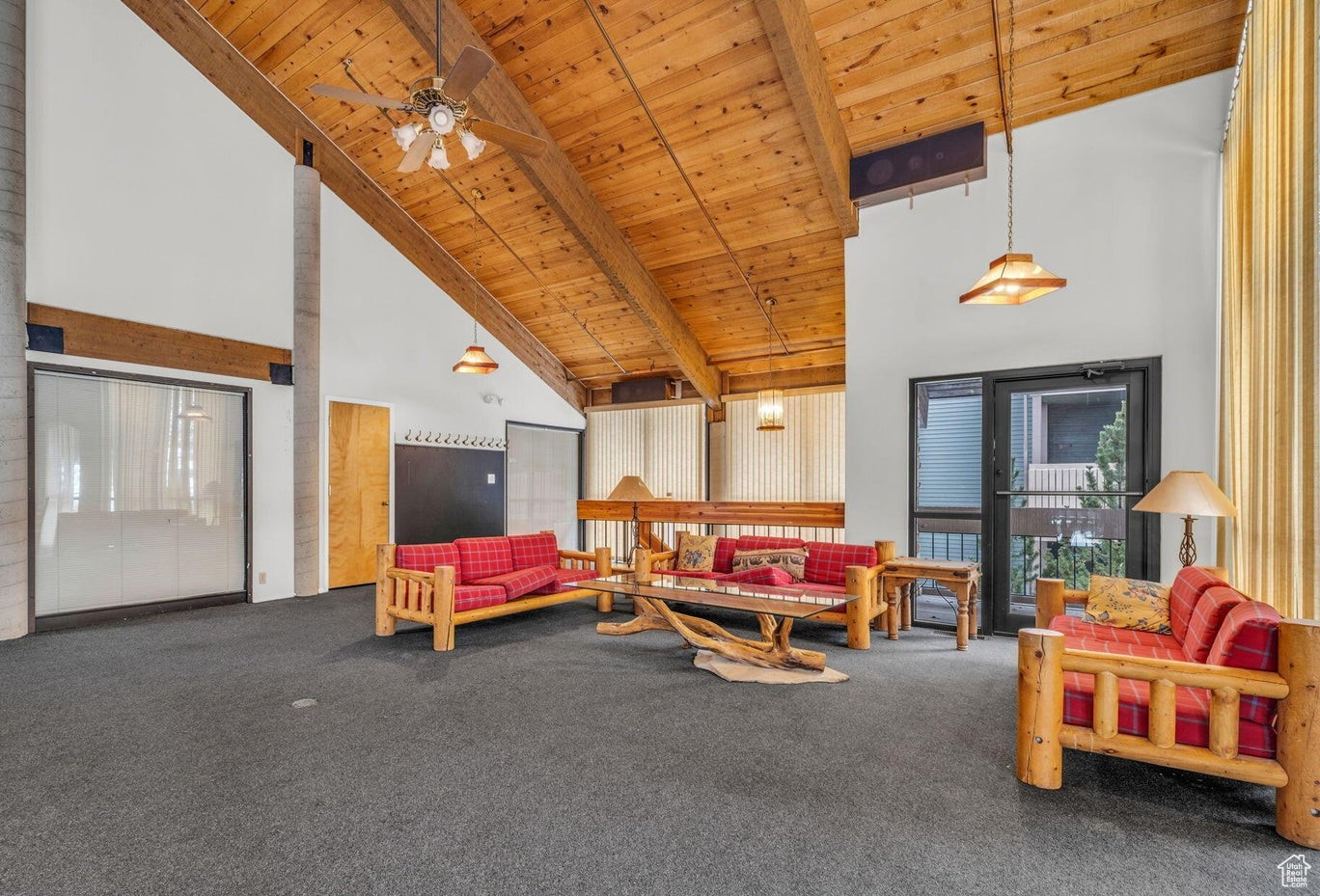 Living room featuring beamed ceiling, carpet flooring, ceiling fan, wooden ceiling, and high vaulted ceiling