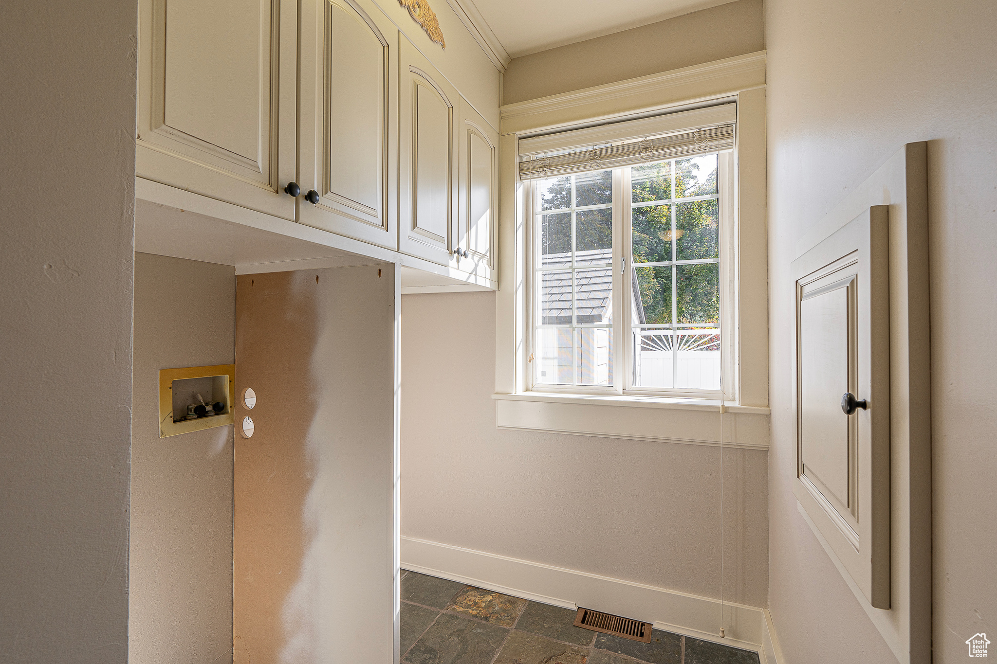 Laundry area featuring washer hookup and cabinets