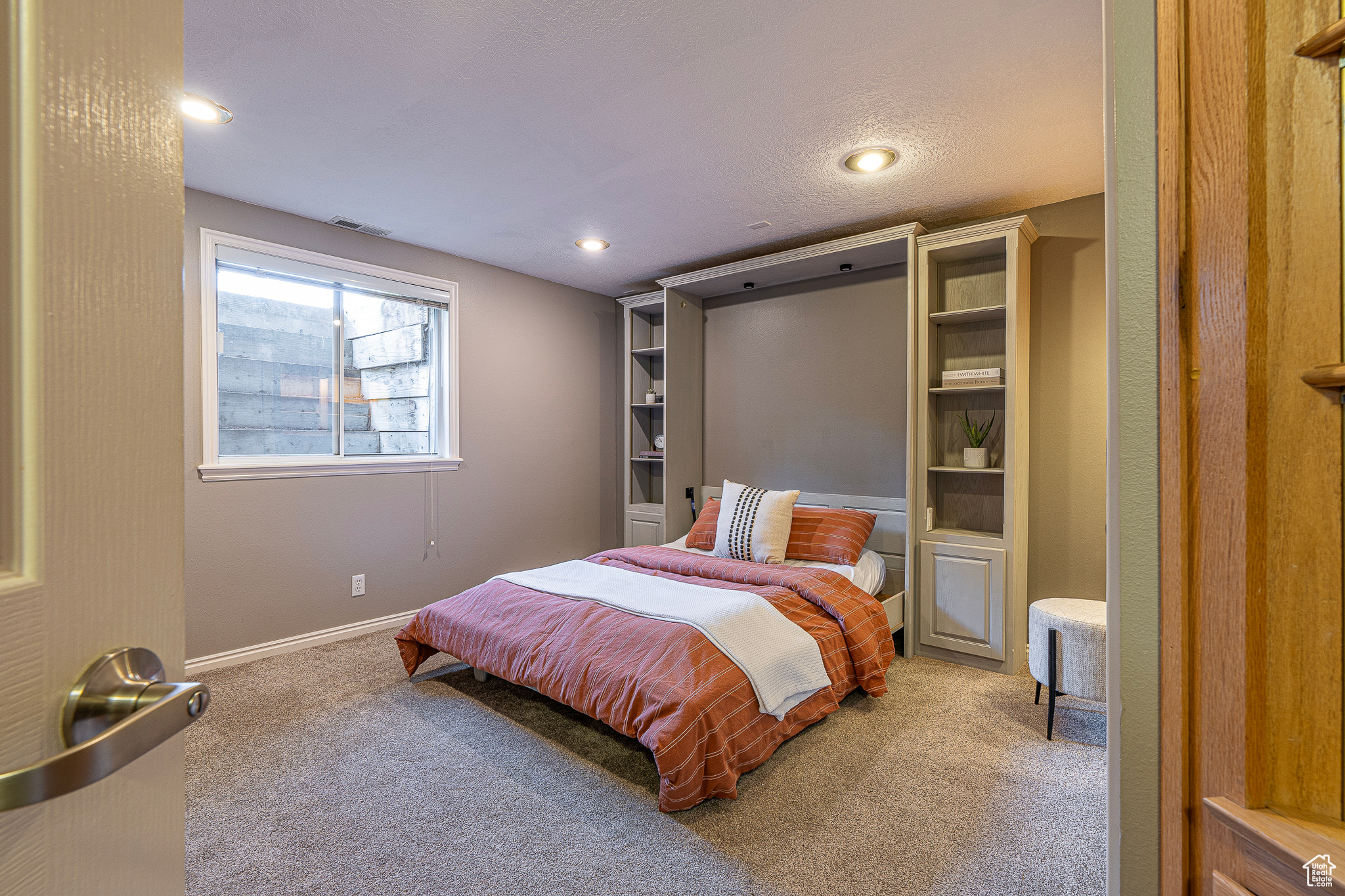 Carpeted bedroom featuring a textured ceiling